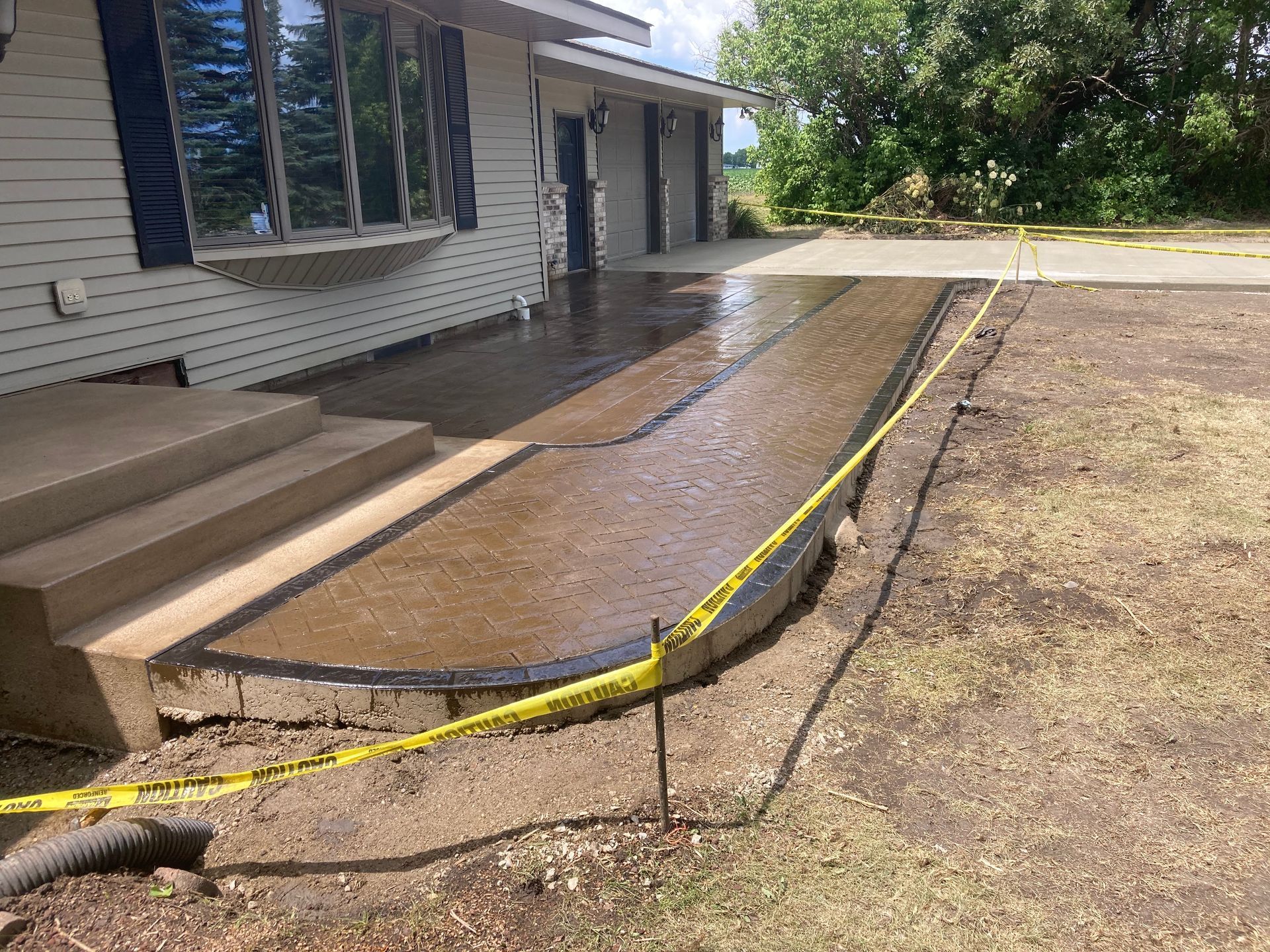 a concrete walkway is being built in front of a house