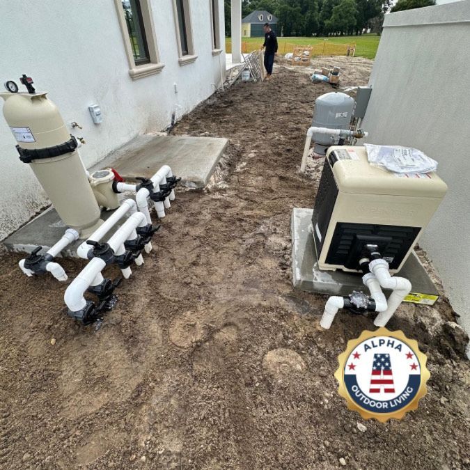 Pool equipment installed beside a white house on dirt ground with a person in the background.