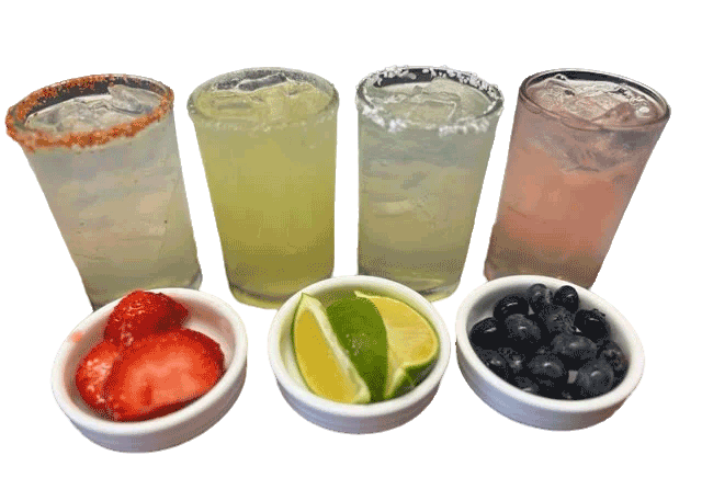 Four glasses of juices garnished with fruit.