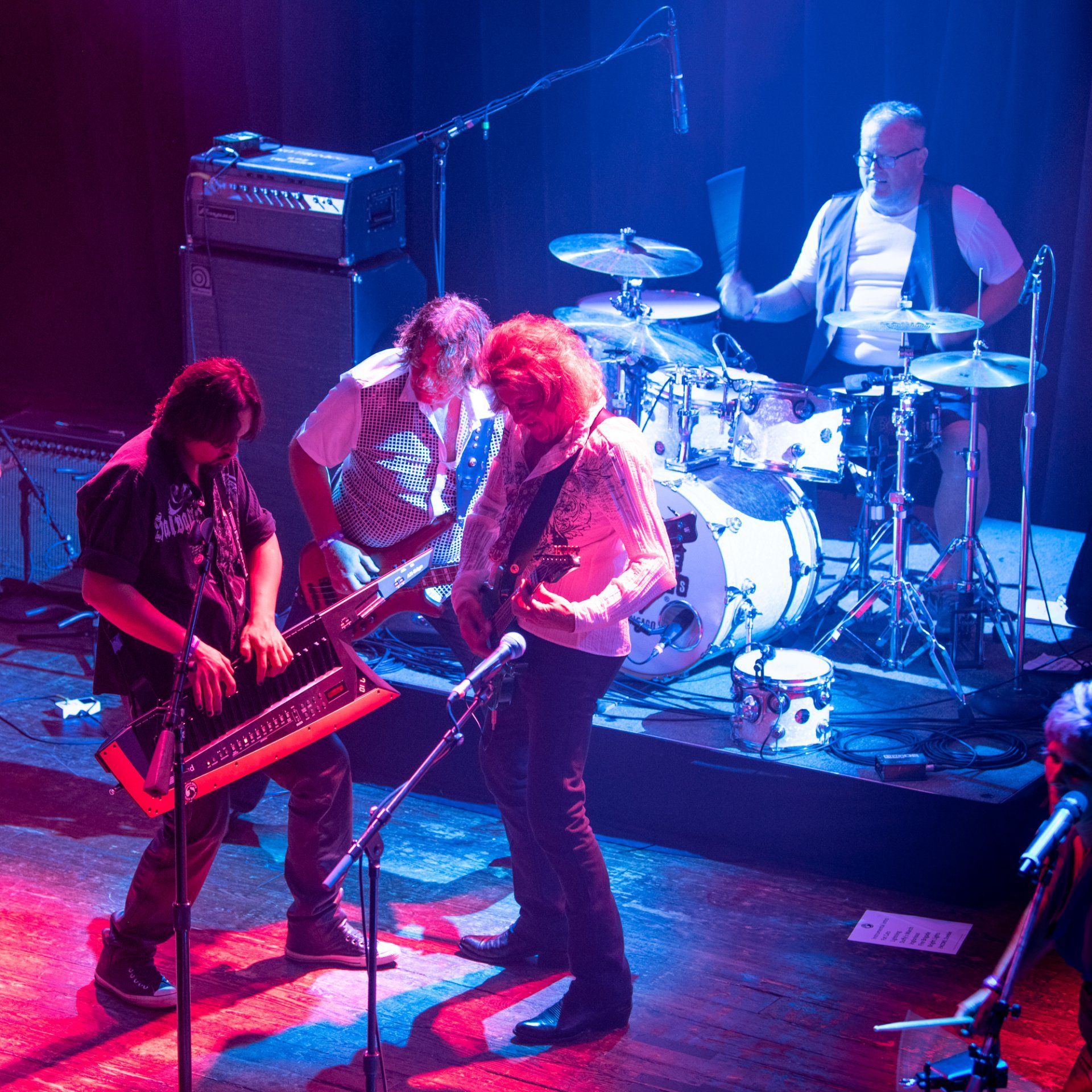 A group of men are playing instruments on a stage