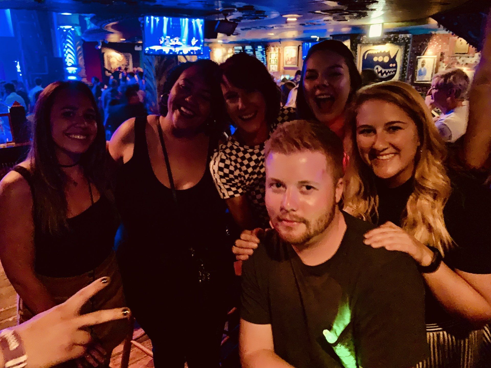 A group of people posing for a picture in a club
