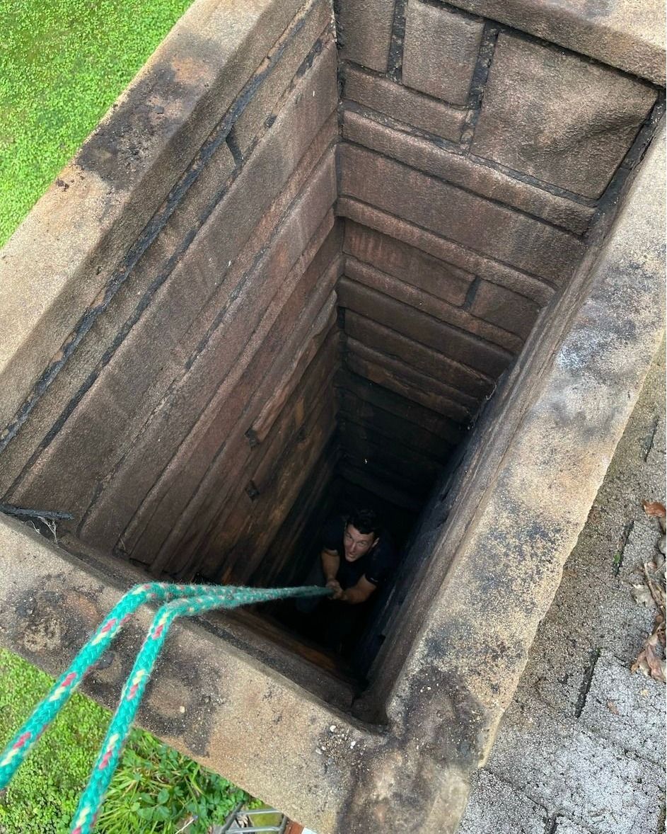 A man is standing in a hole in the ground.