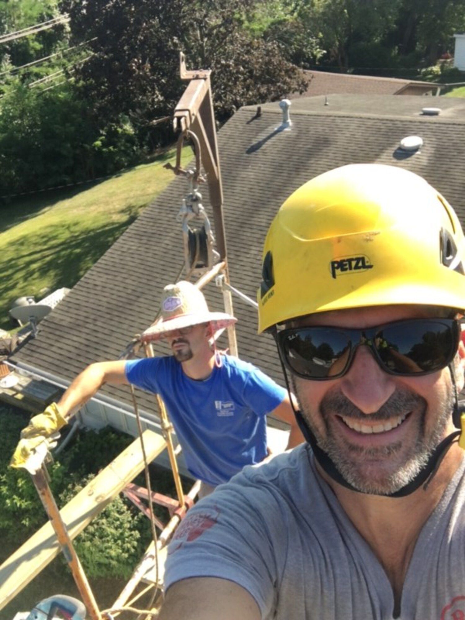A man wearing a yellow helmet that says petzl on it