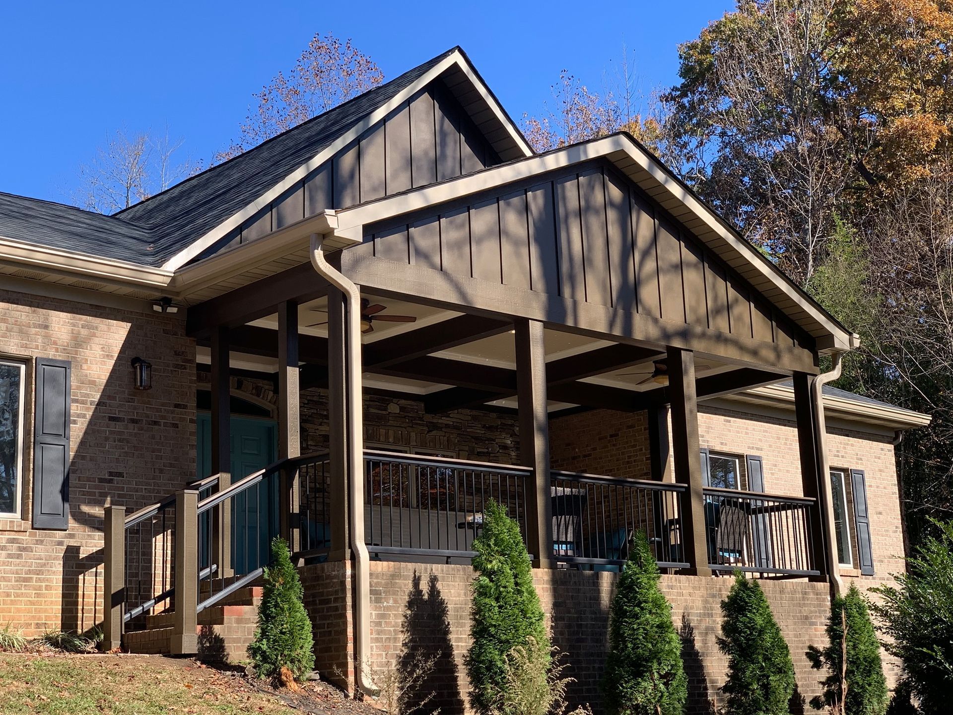 A brick house with a large porch and stairs