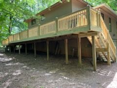 A large wooden deck is sitting on top of a house.