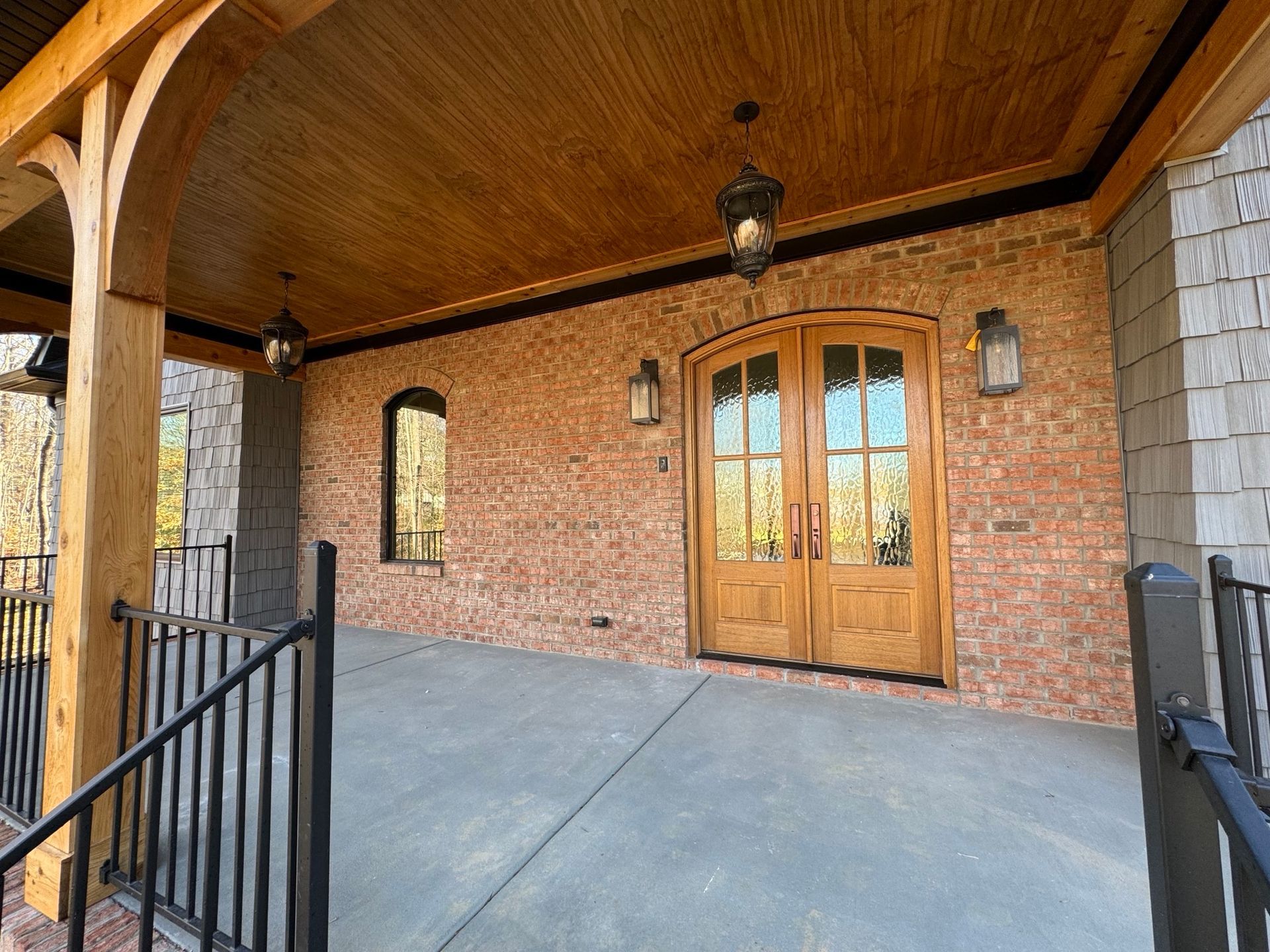A large brick building with wooden doors and a wooden ceiling