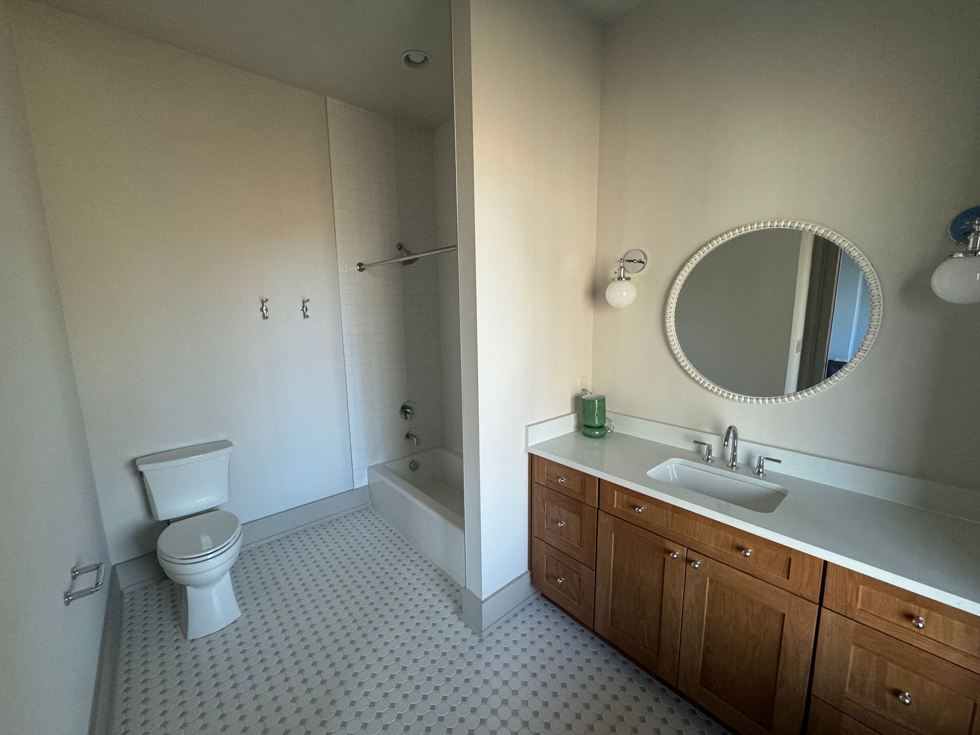 A bathroom with a toilet , sink , and mirror.