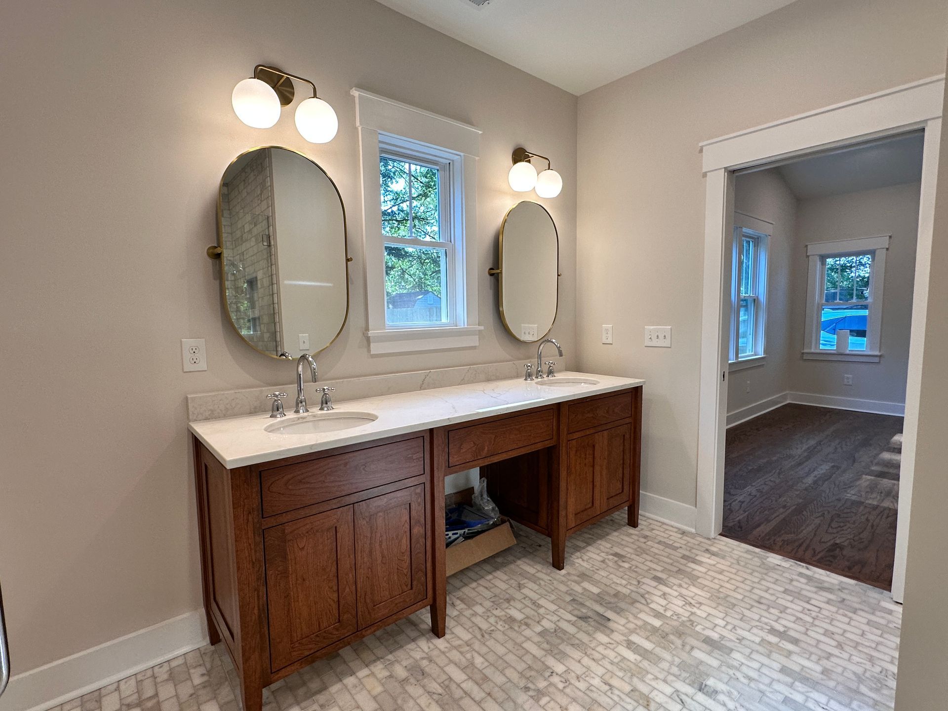 A bathroom with two sinks and two mirrors.