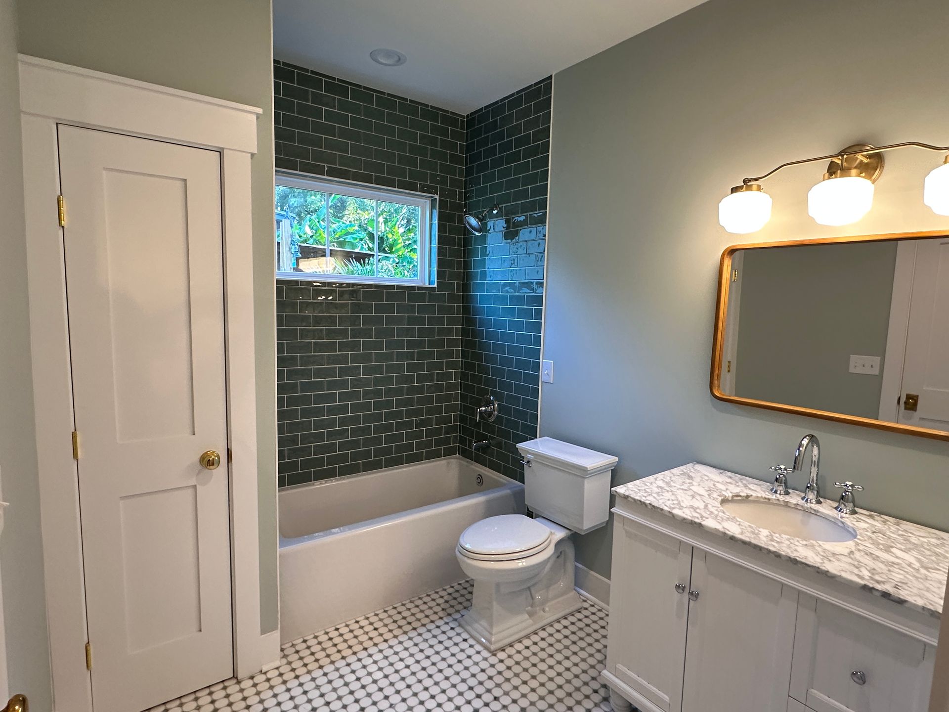 A bathroom with a toilet , sink , and bathtub.