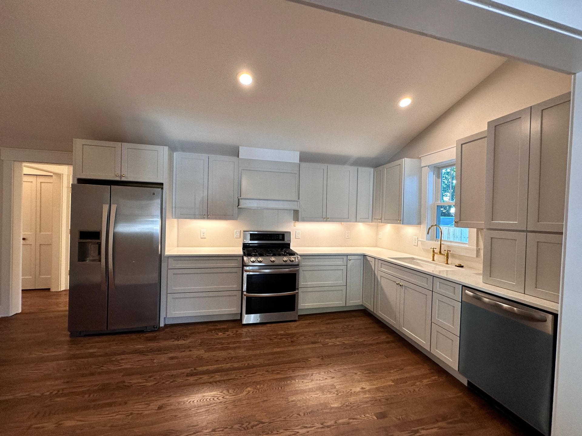 A kitchen with white cabinets and stainless steel appliances