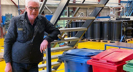 Karsten Lykkegaard with some of the waste bins at the factory