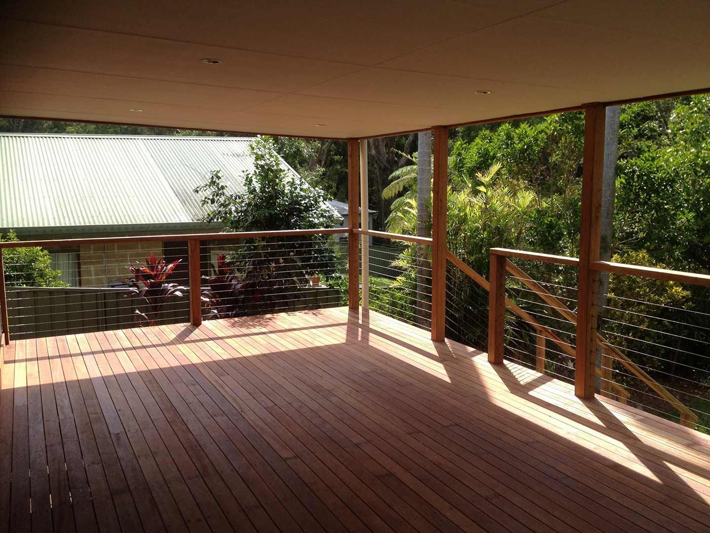 A Wooden Deck With A Wire Railing And A View Of A House — Nambucca Construction In Nambucca Heads, NSW