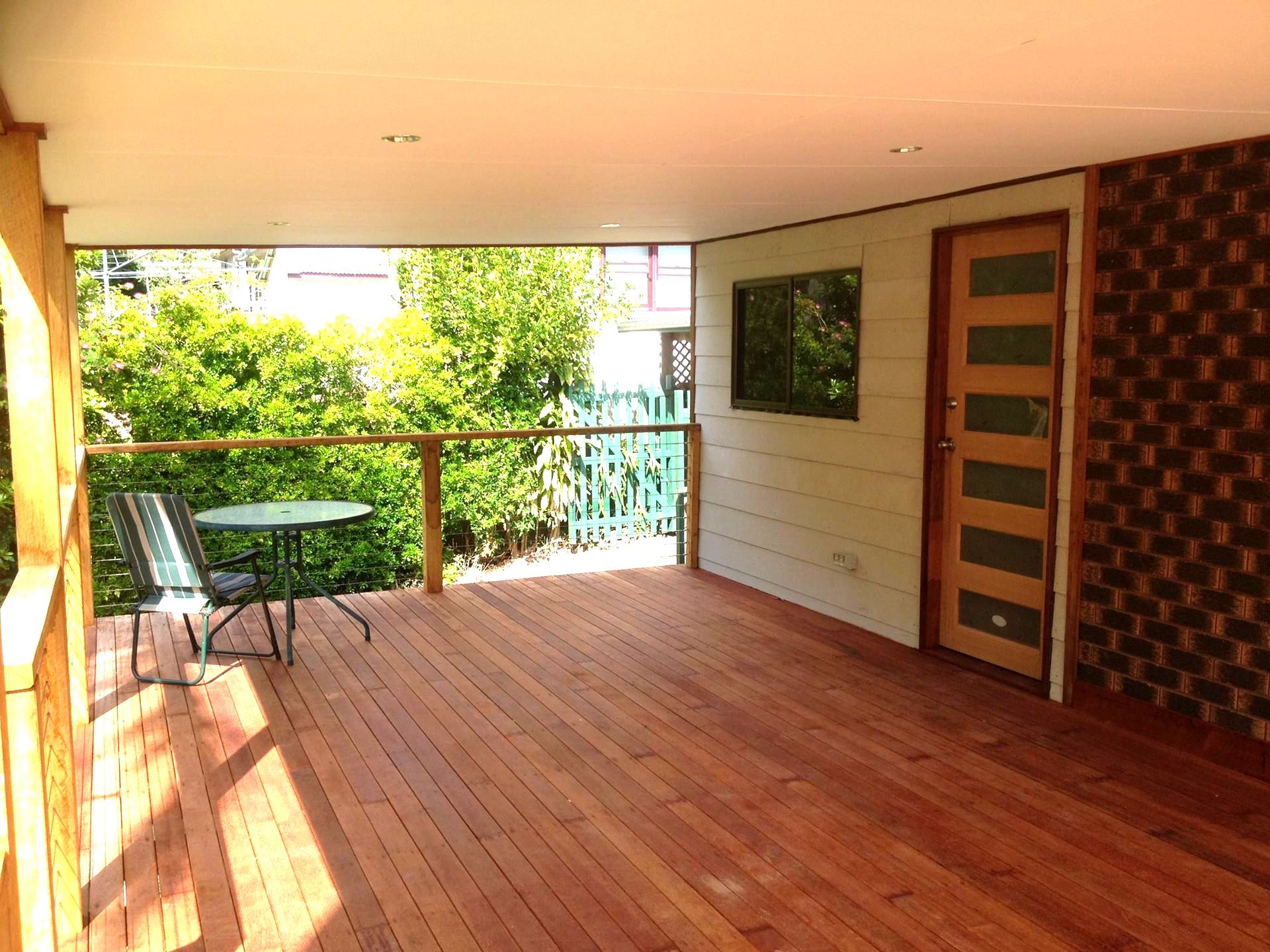 A Car Is Parked Under A Deck In Front Of A House — Nambucca Construction In Nambucca Heads, NSW