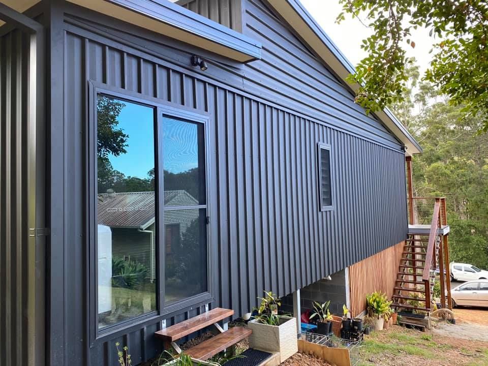 A Blue House with a lot of Windows and stairs — Nambucca Construction In Nambucca Heads, NSW