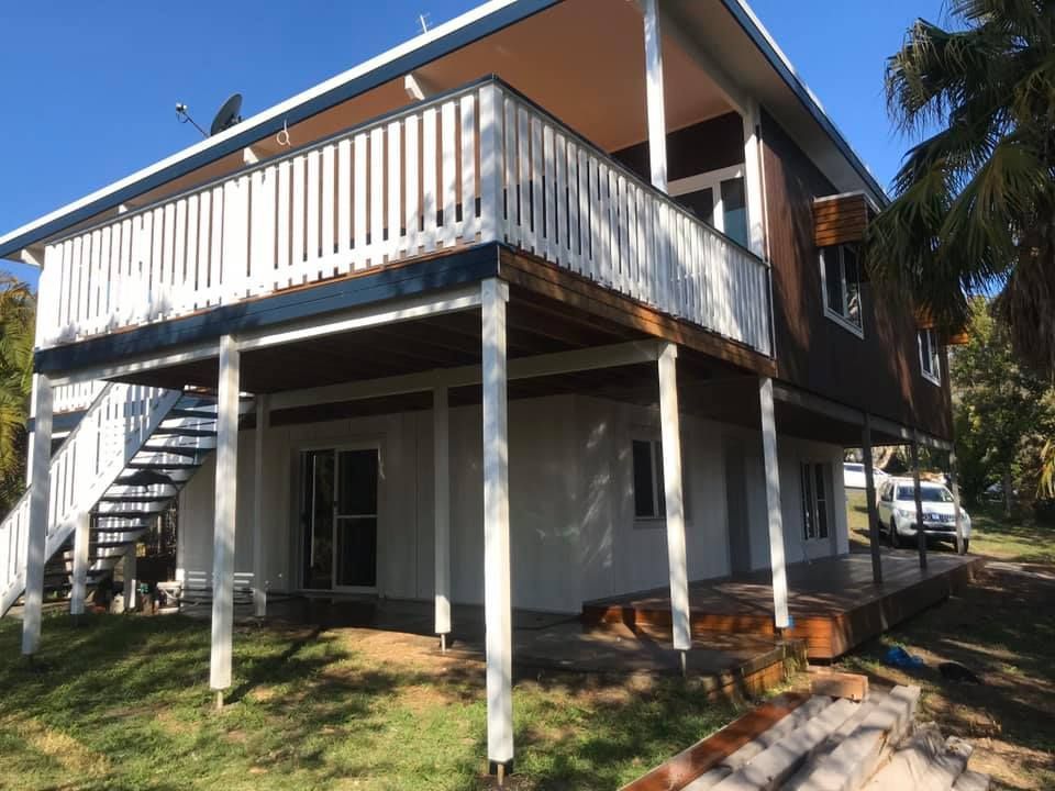 A House With A Balcony And Stairs On The Side Of It — Nambucca Construction In Macksville, NSW