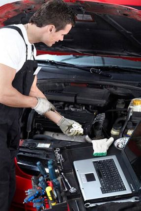 Mechanic checking oil