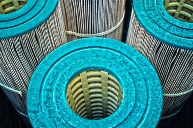 A close up of three pool filter cartridges with a hole in the middle.