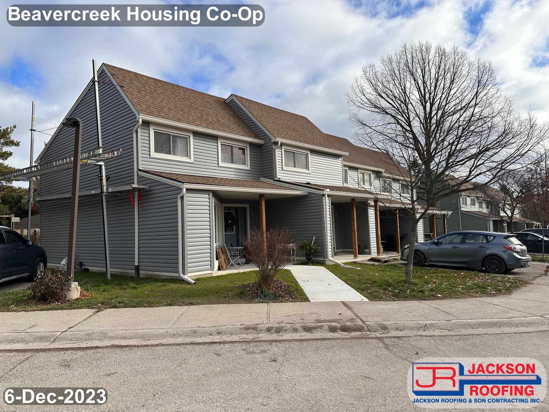 A picture of a house with a car parked in front of it.