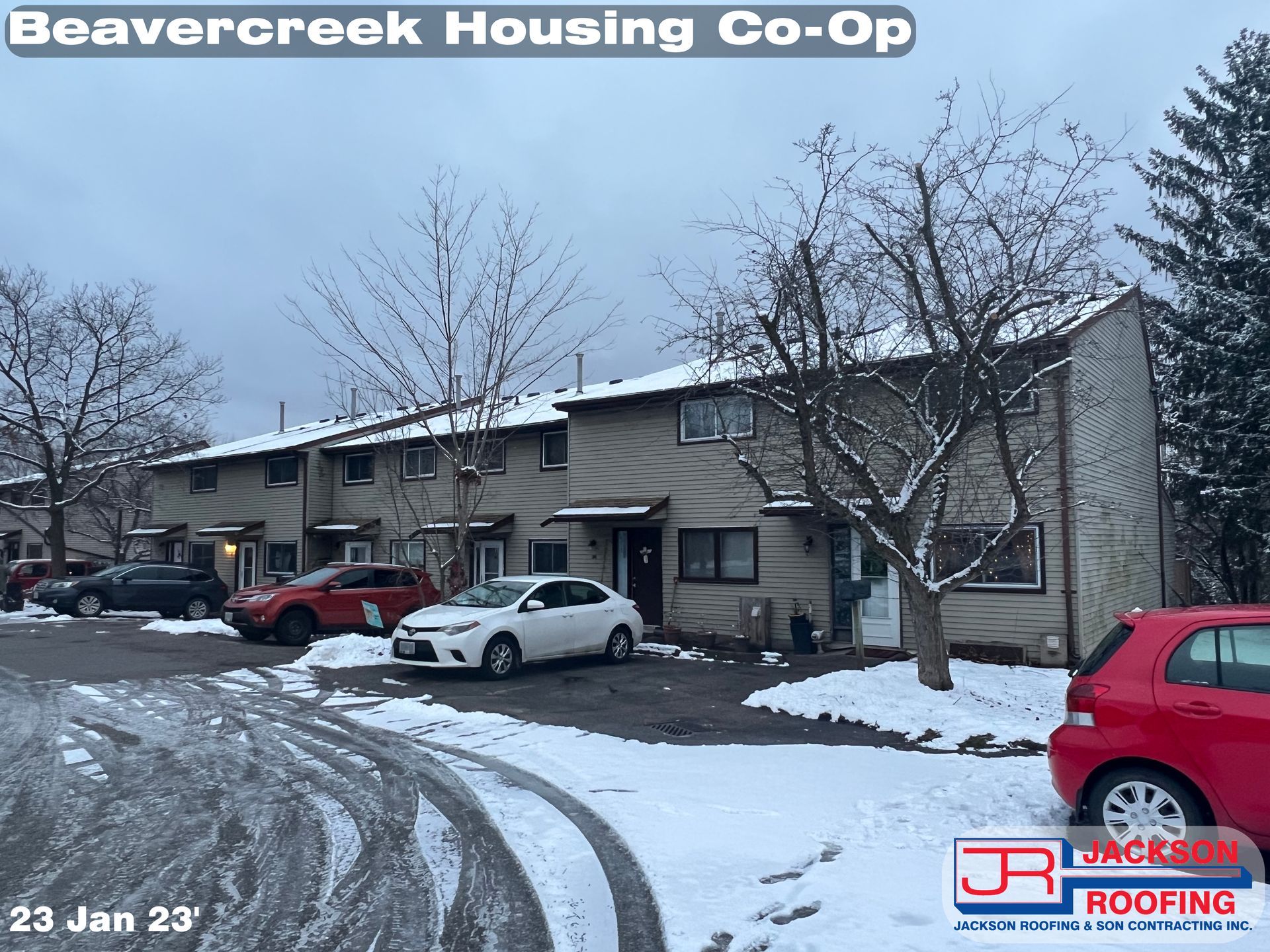 A red car is parked in front of a beavercreek housing co-op