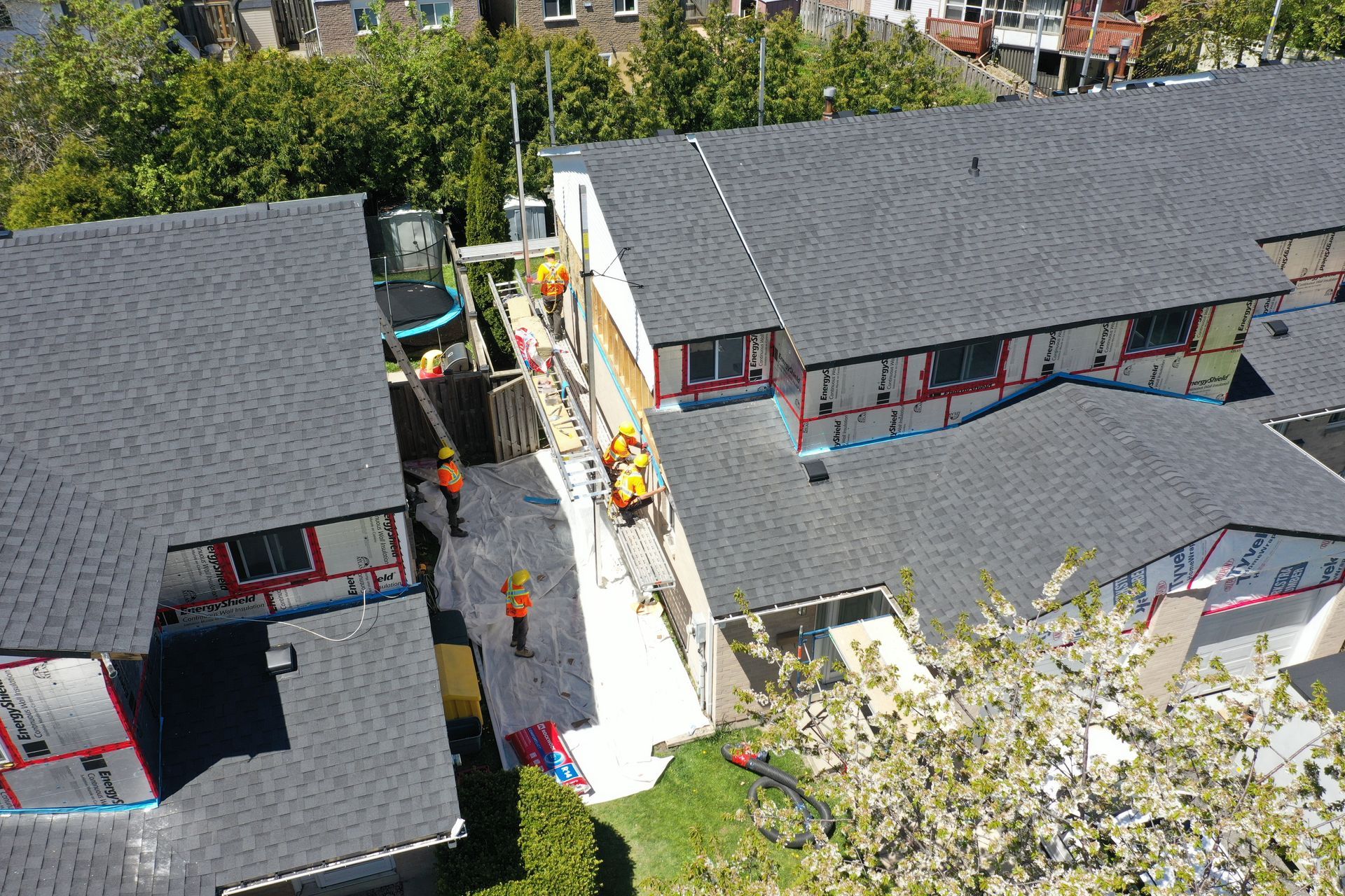 A group of people are working on the roof of a building.