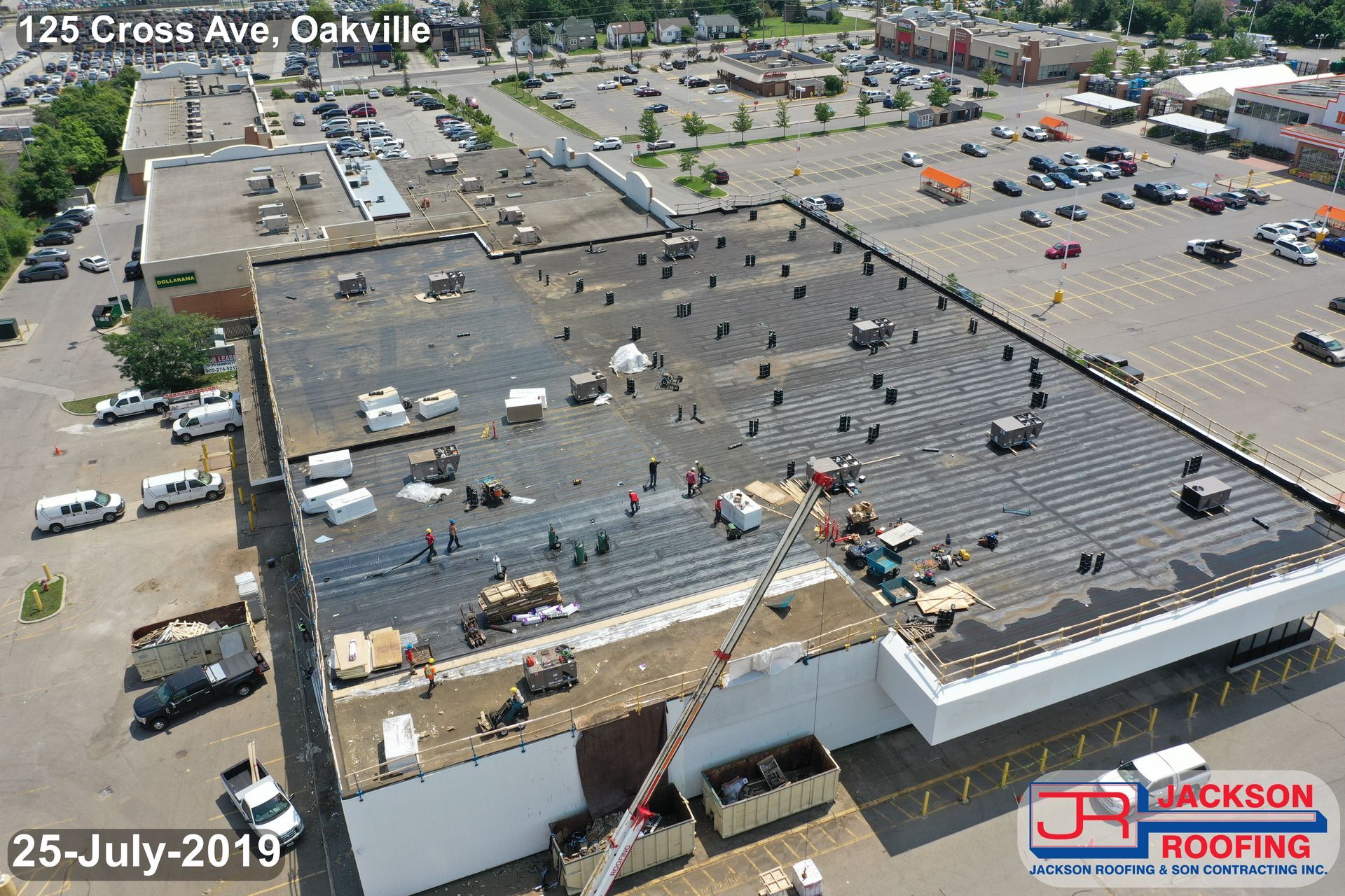 An aerial view of a building with a crane on the roof.