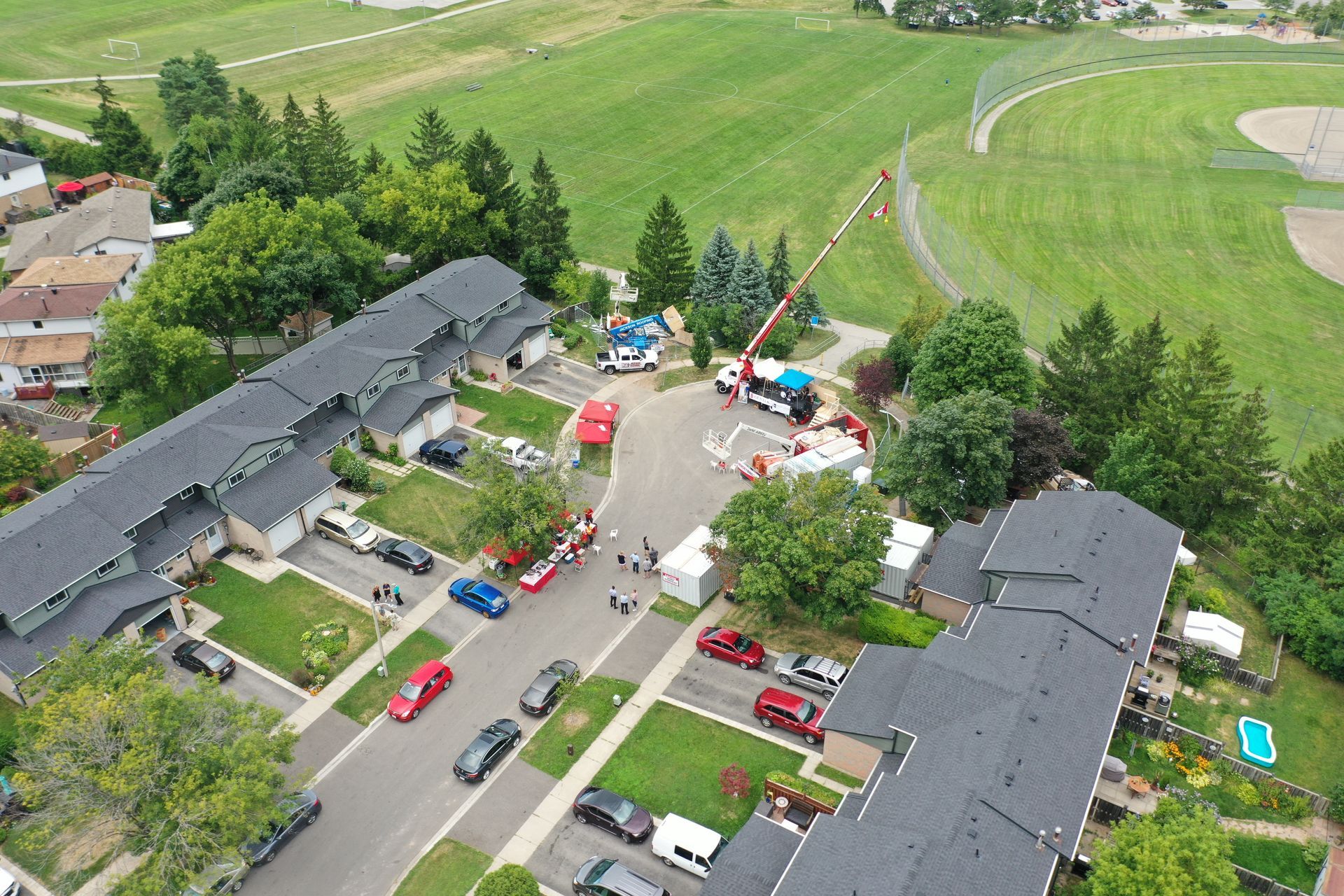 An aerial view of a residential area with a park in the background.