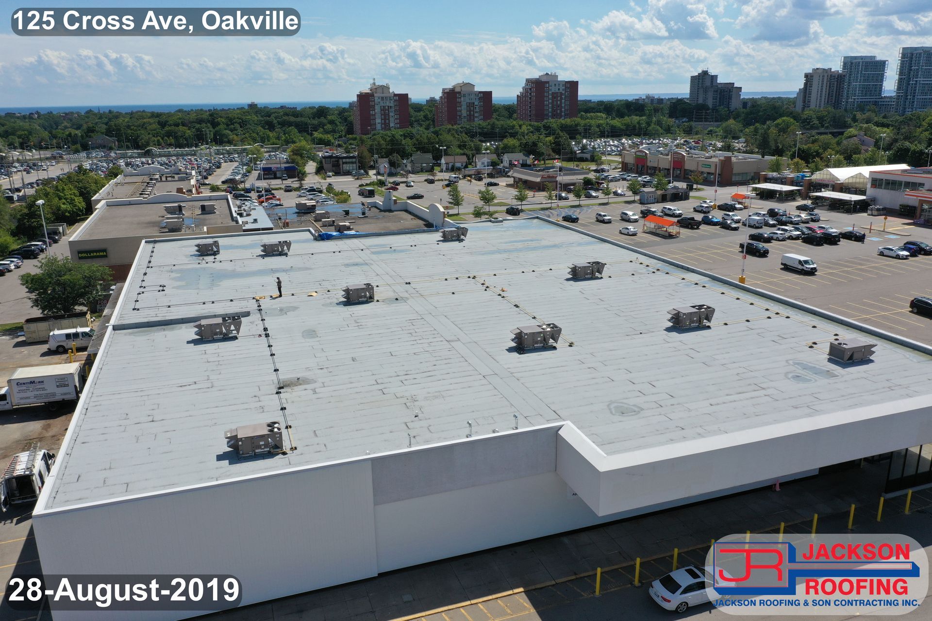 An aerial view of a large building with a white roof.