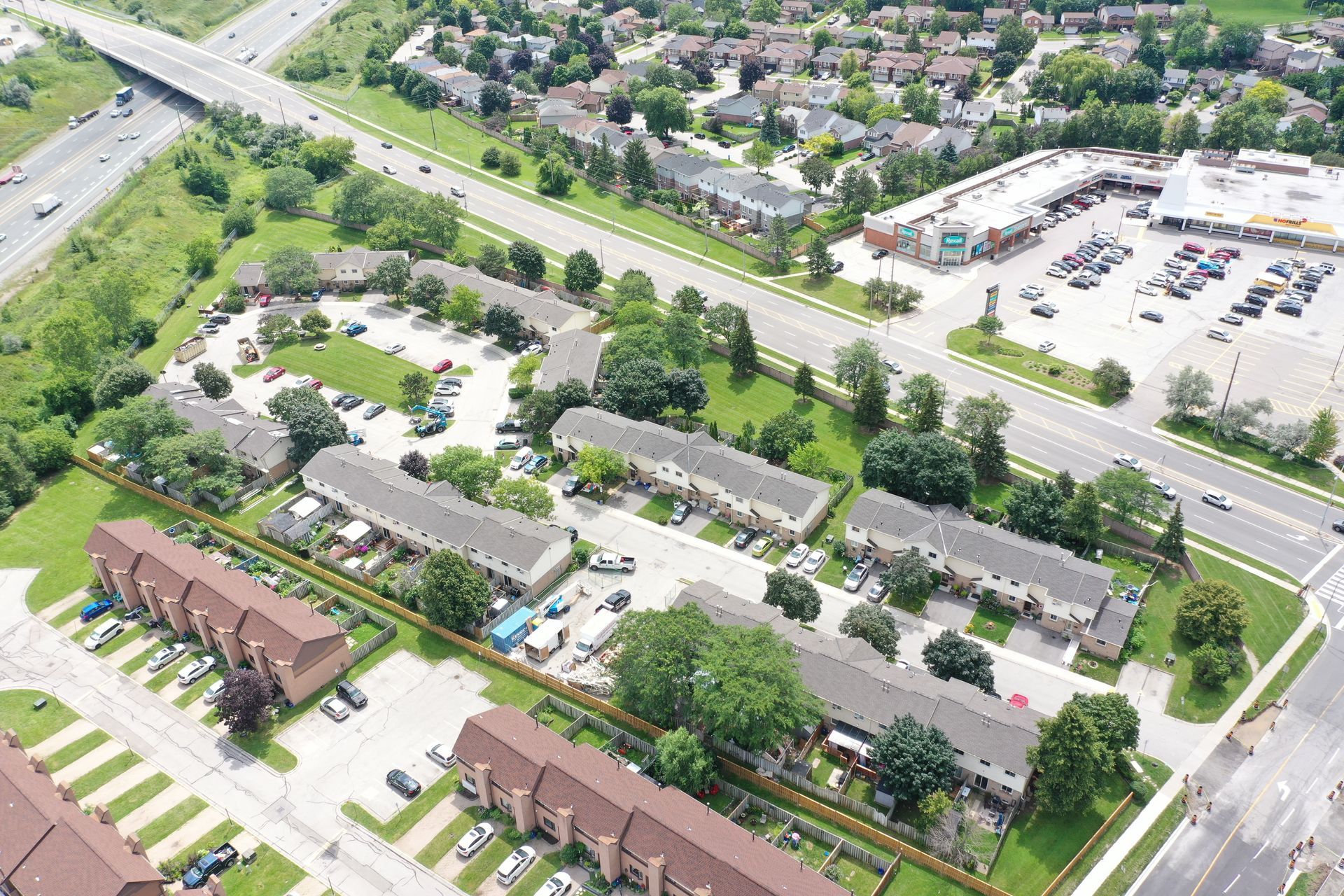 An aerial view of a residential area with lots of buildings and parking lots