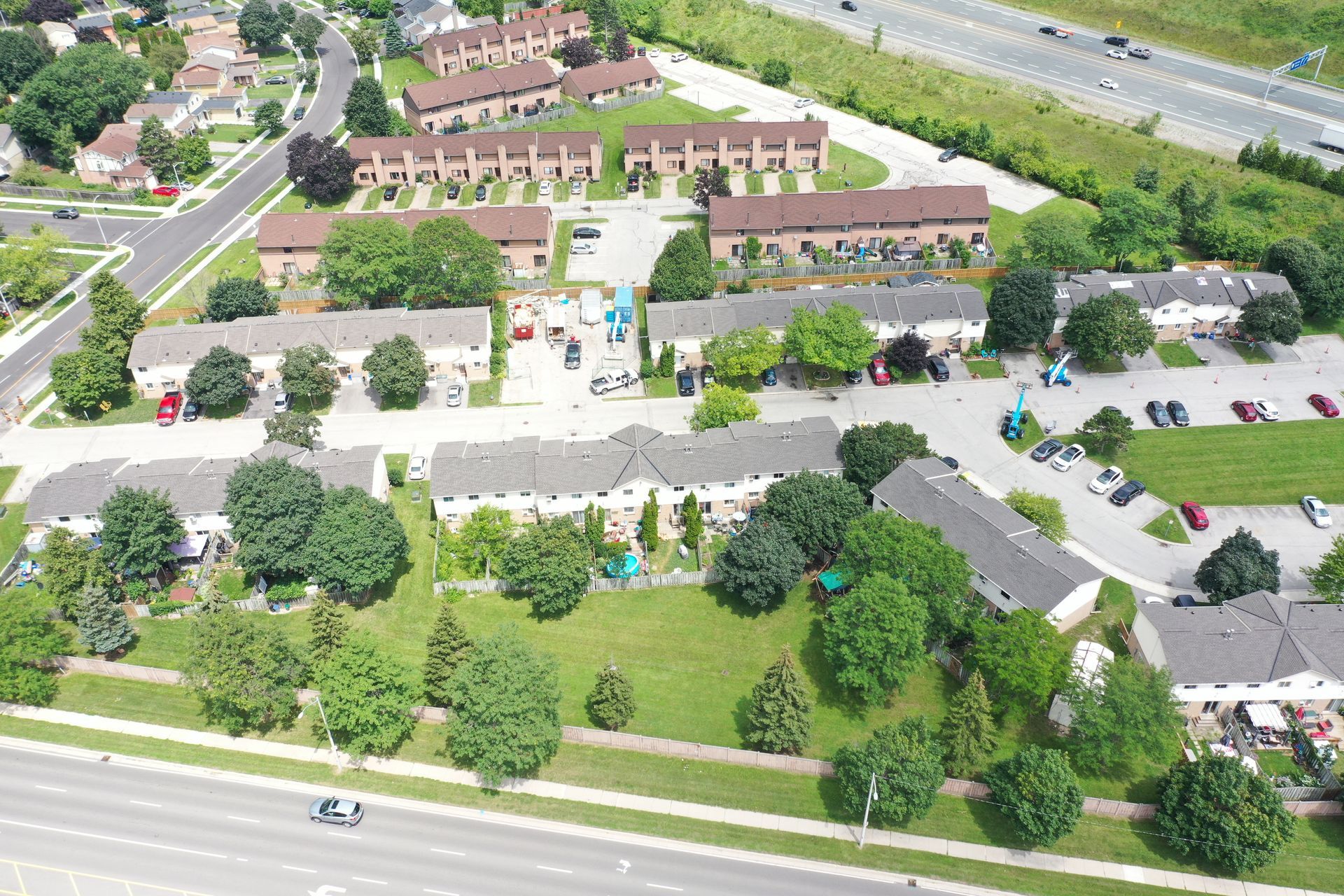 An aerial view of a residential area with a highway in the background