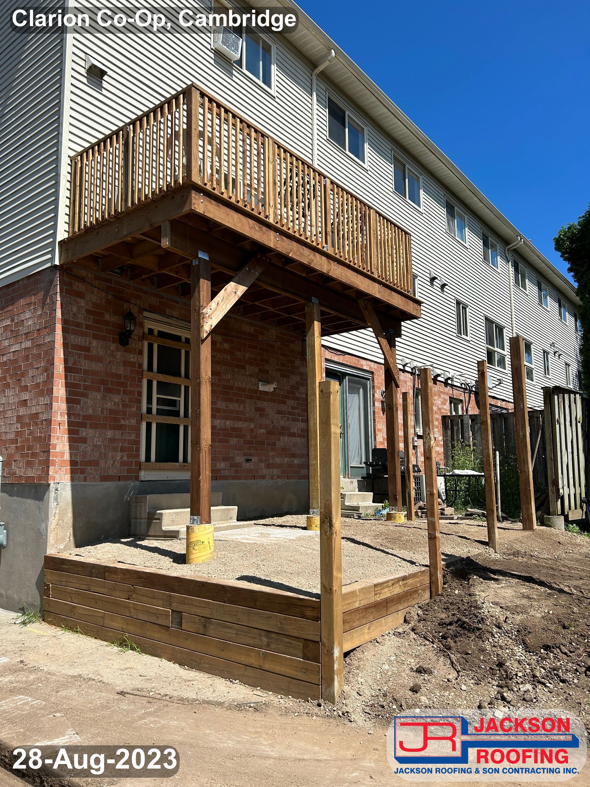 A wooden deck is being built on the side of a house.