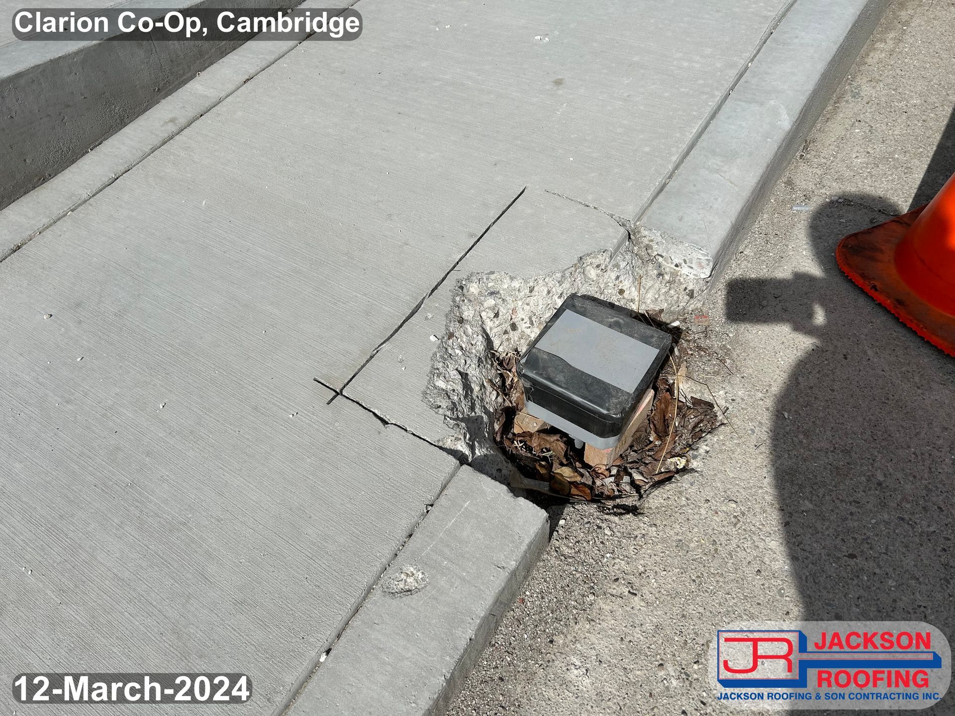 A phone is laying on the sidewalk in clarion co-op cambridge