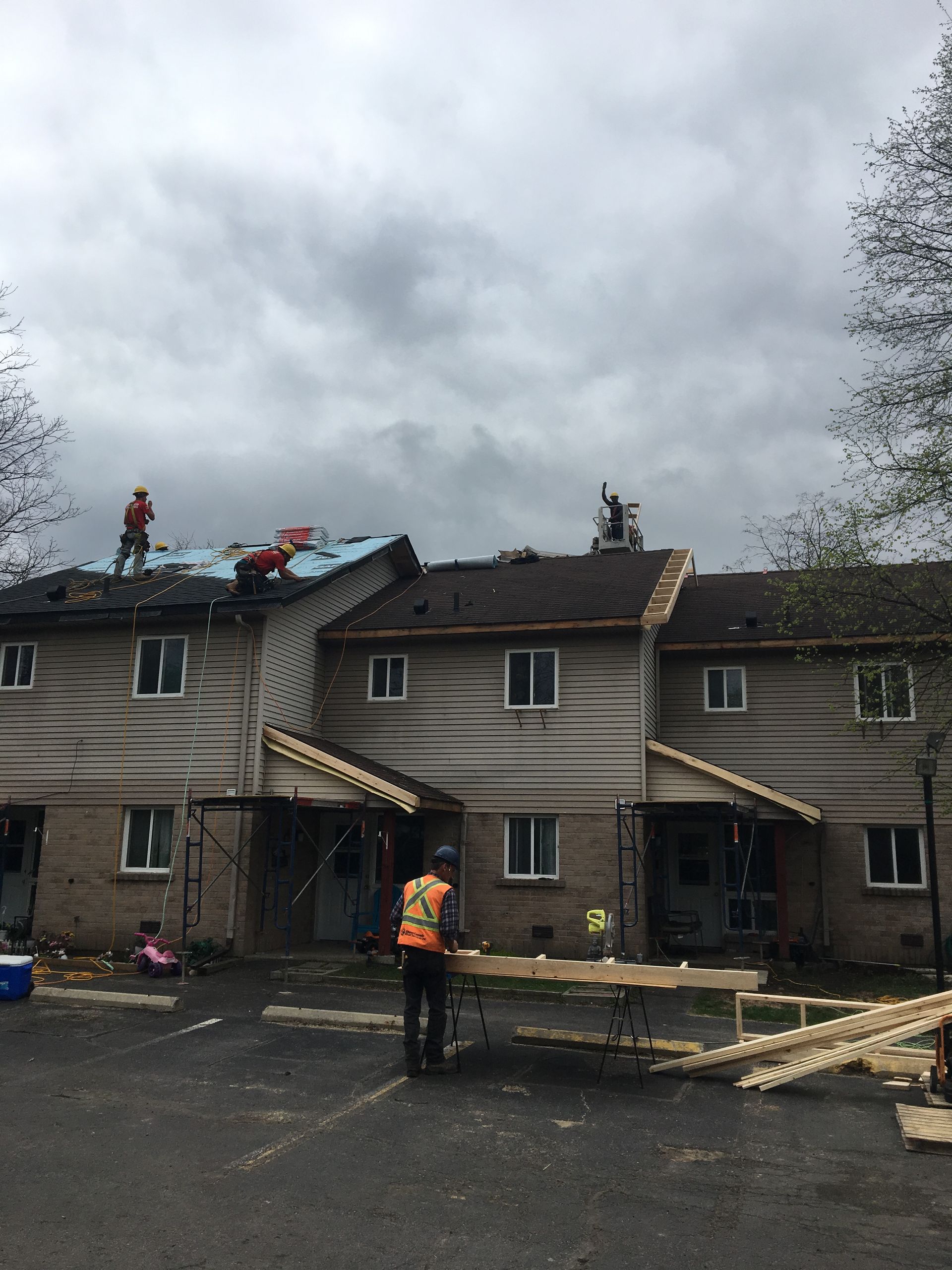A group of people are working on the roof of a building.