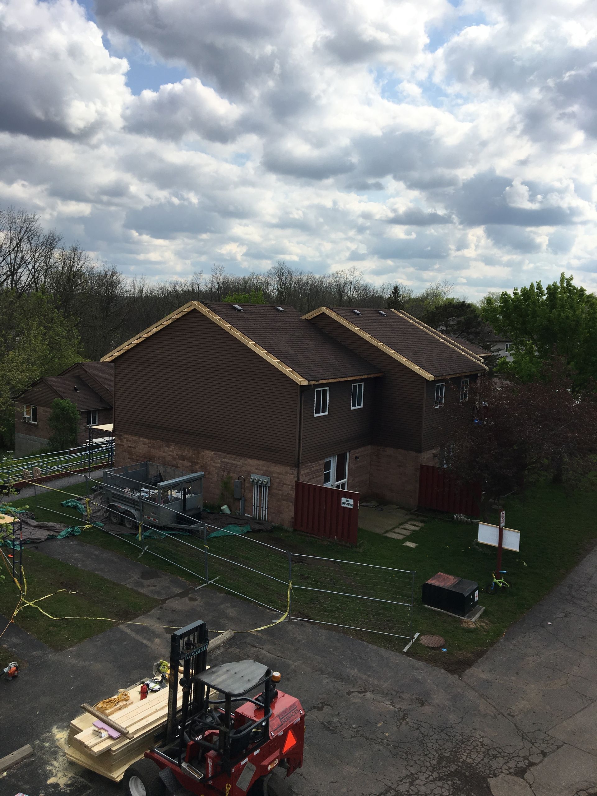 An aerial view of a house with a forklift in front of it