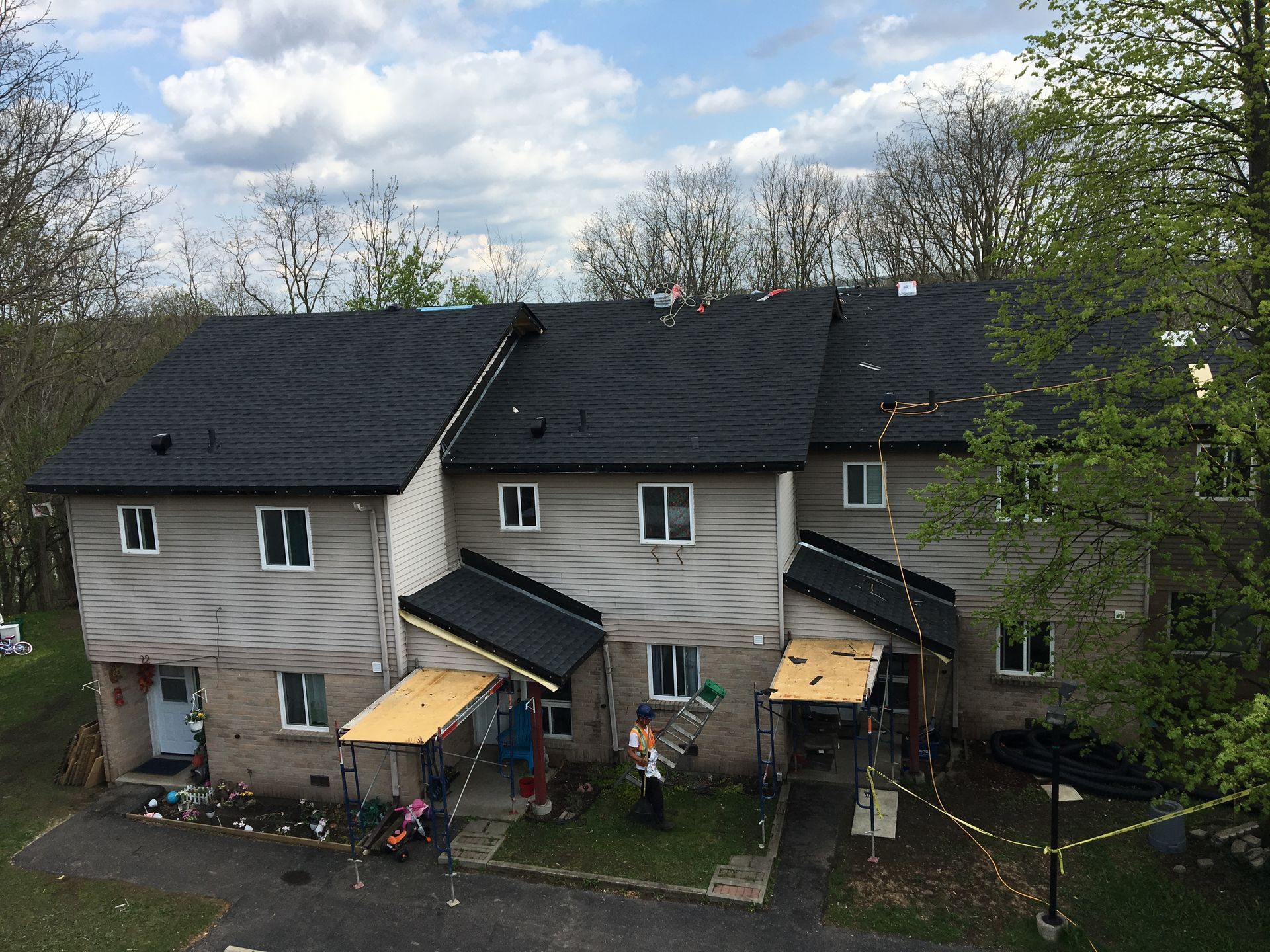 An aerial view of a row of houses with a black roof.
