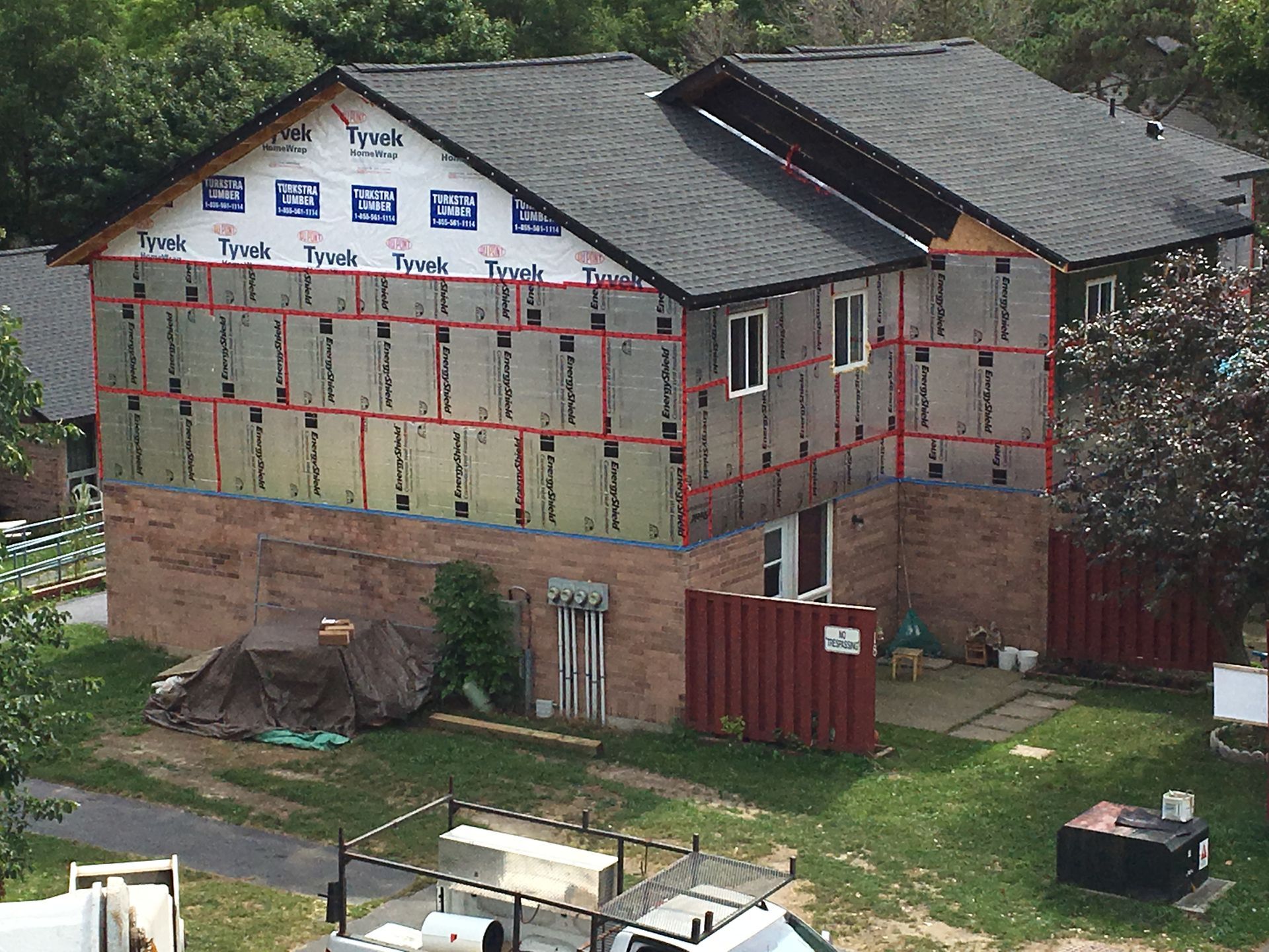 A large brick building with a roof that is being built