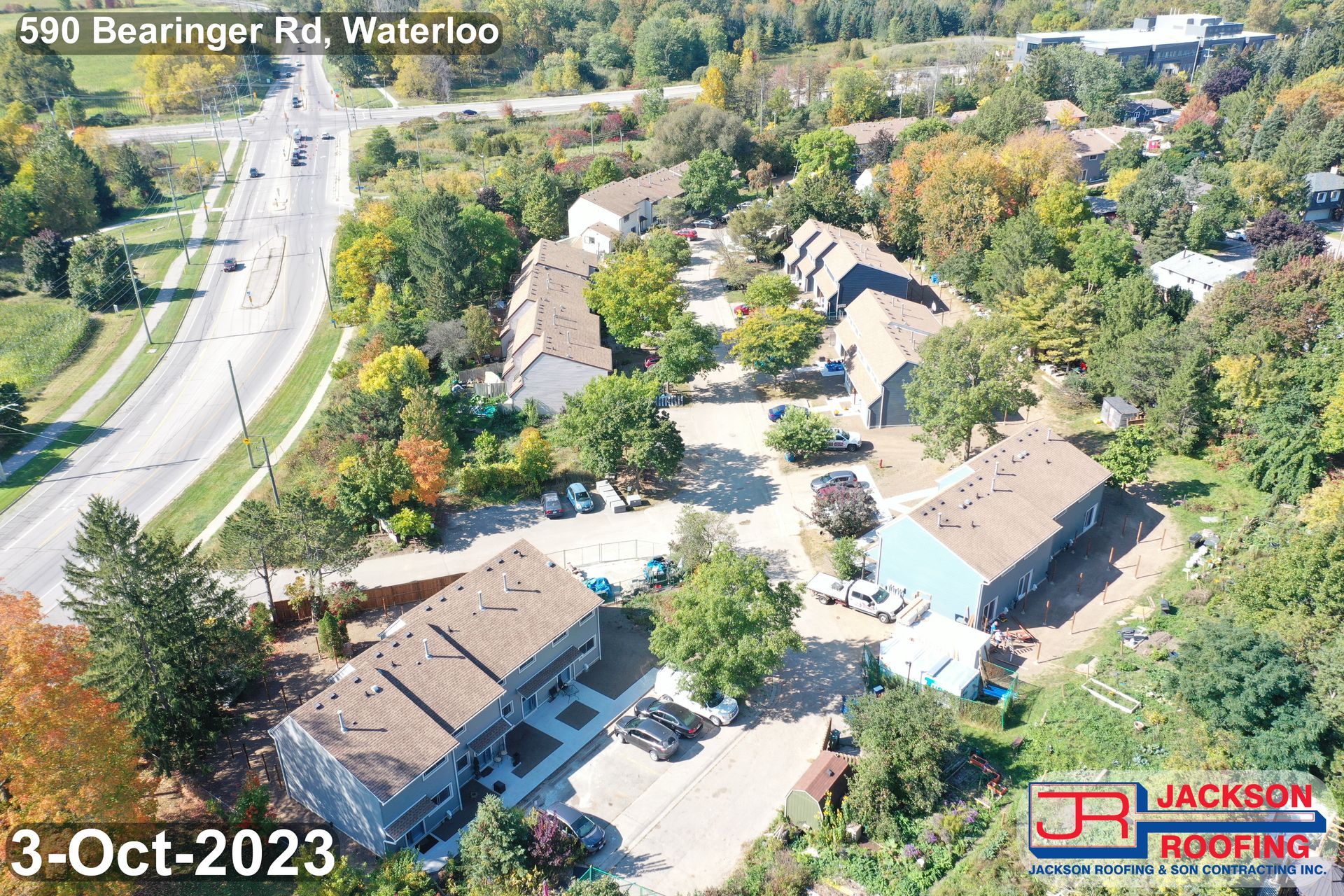 An aerial view of a residential area with a jackson roofing company logo