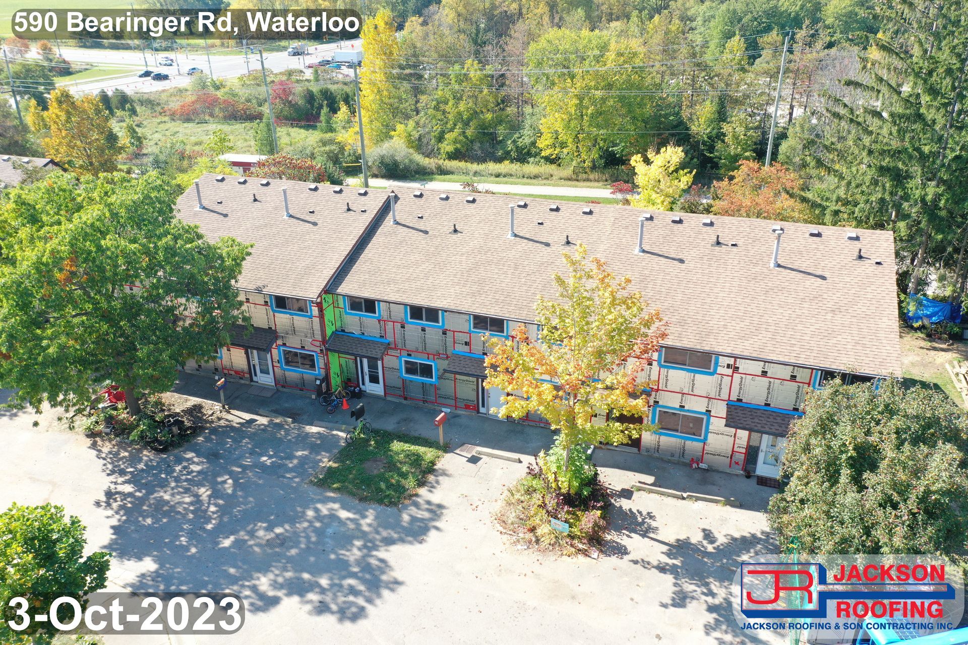 An aerial view of a building under construction surrounded by trees.