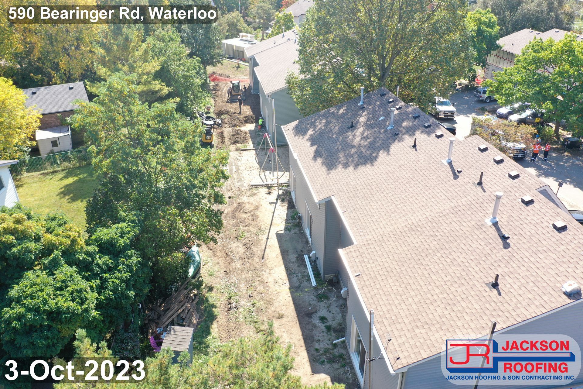 An aerial view of a house with a roof that is being repaired.