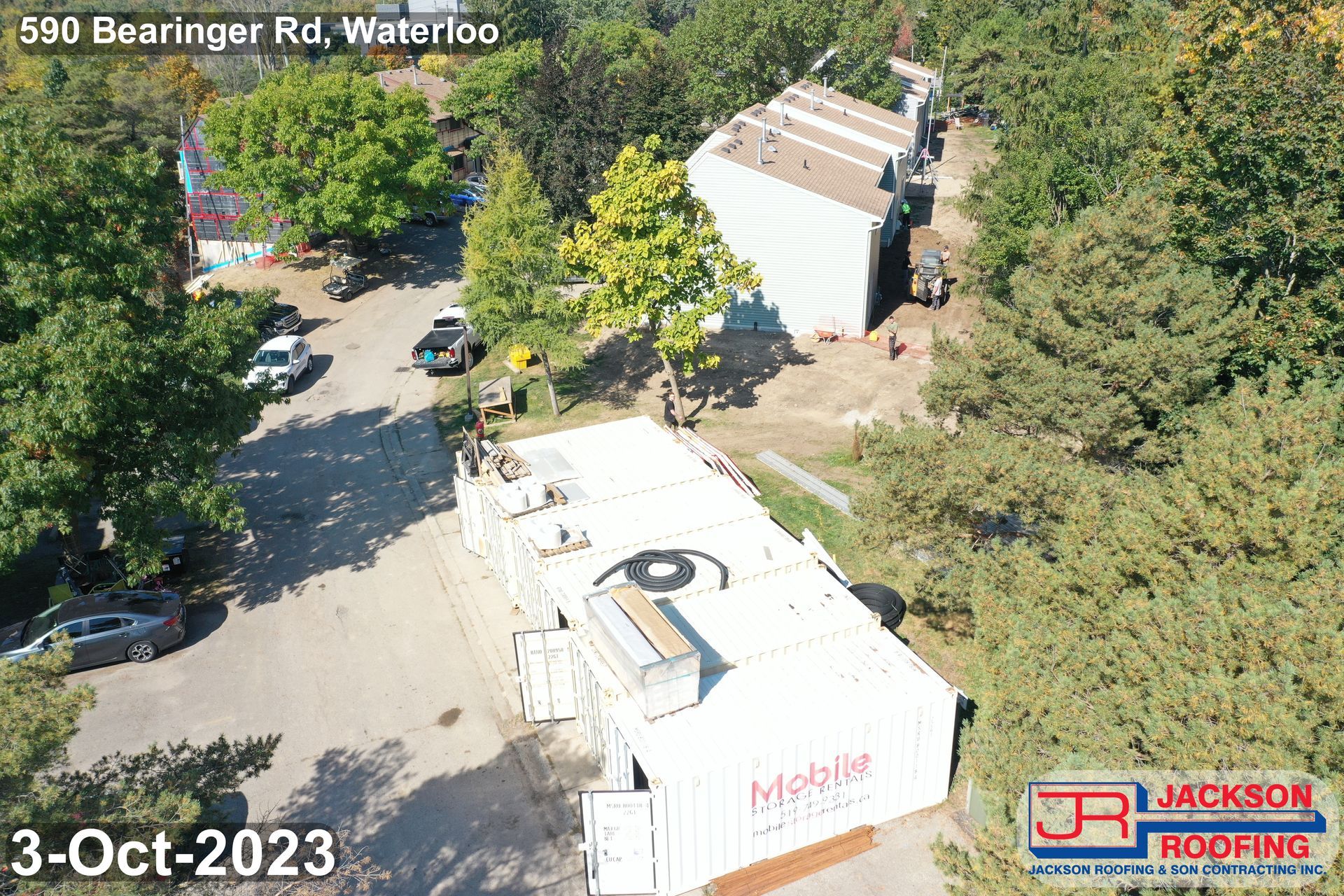 An aerial view of a building with a large eye on the roof.