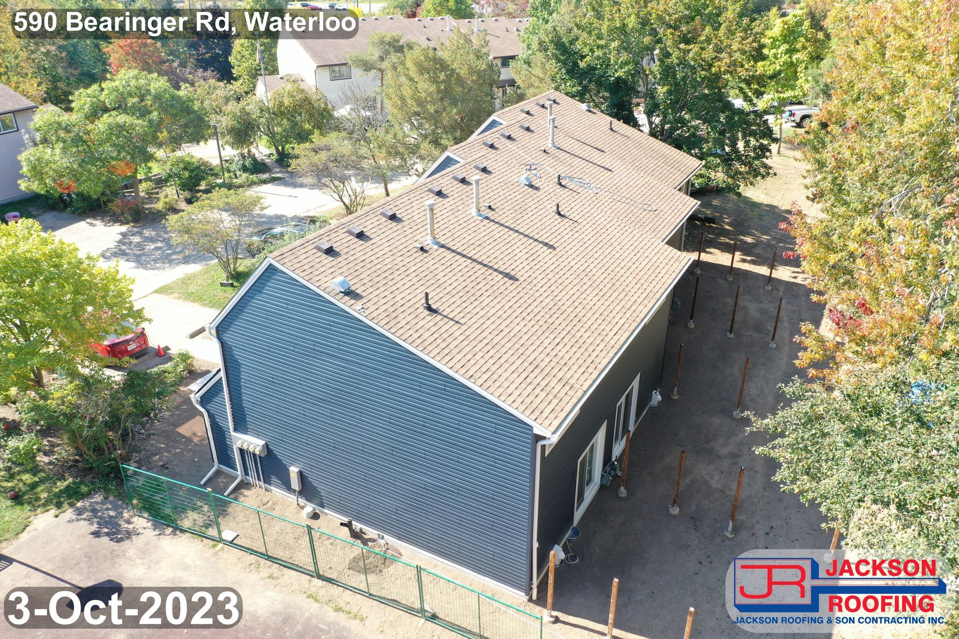 An aerial view of a house with a roof that is being installed.