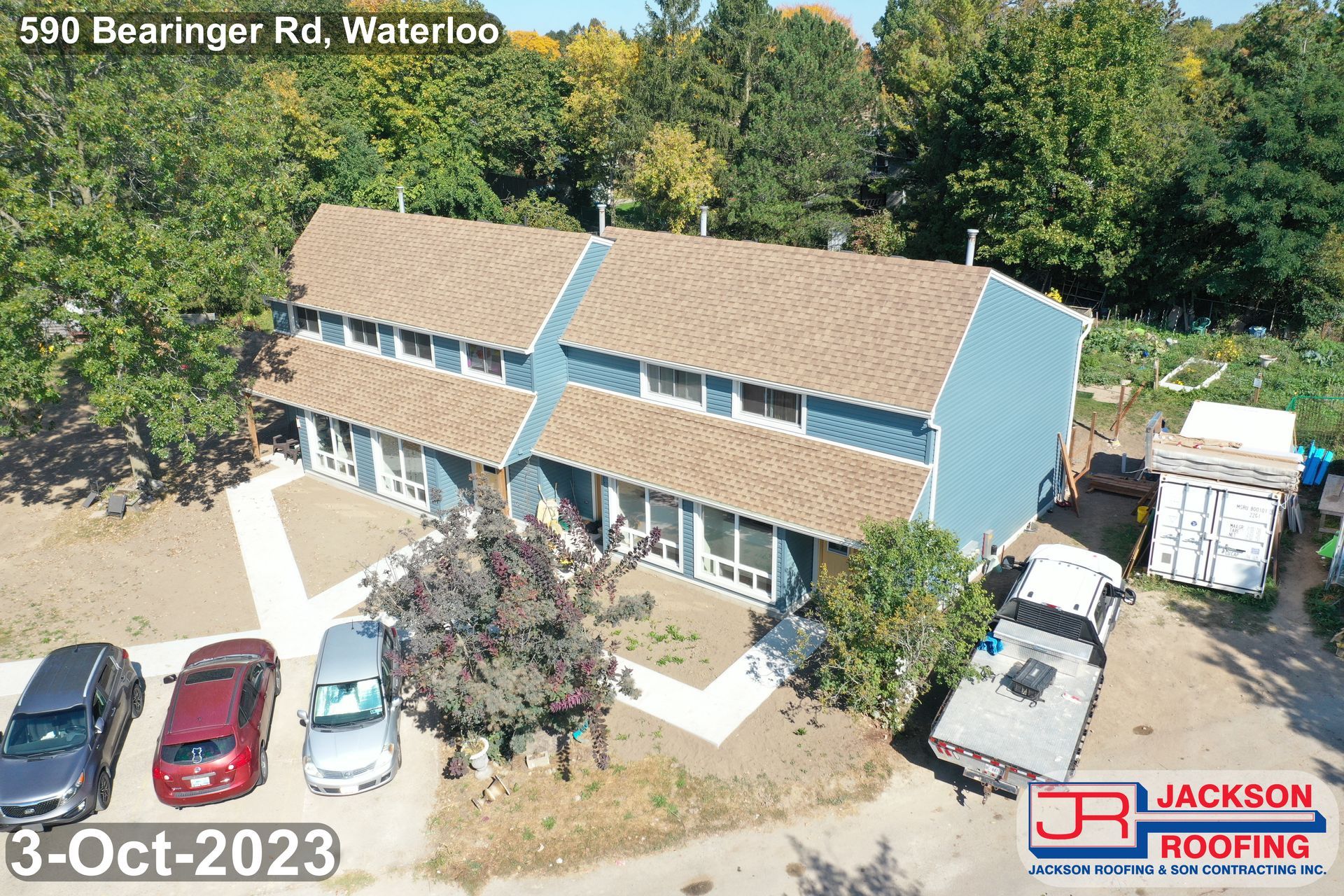 An aerial view of a house with cars parked in front of it