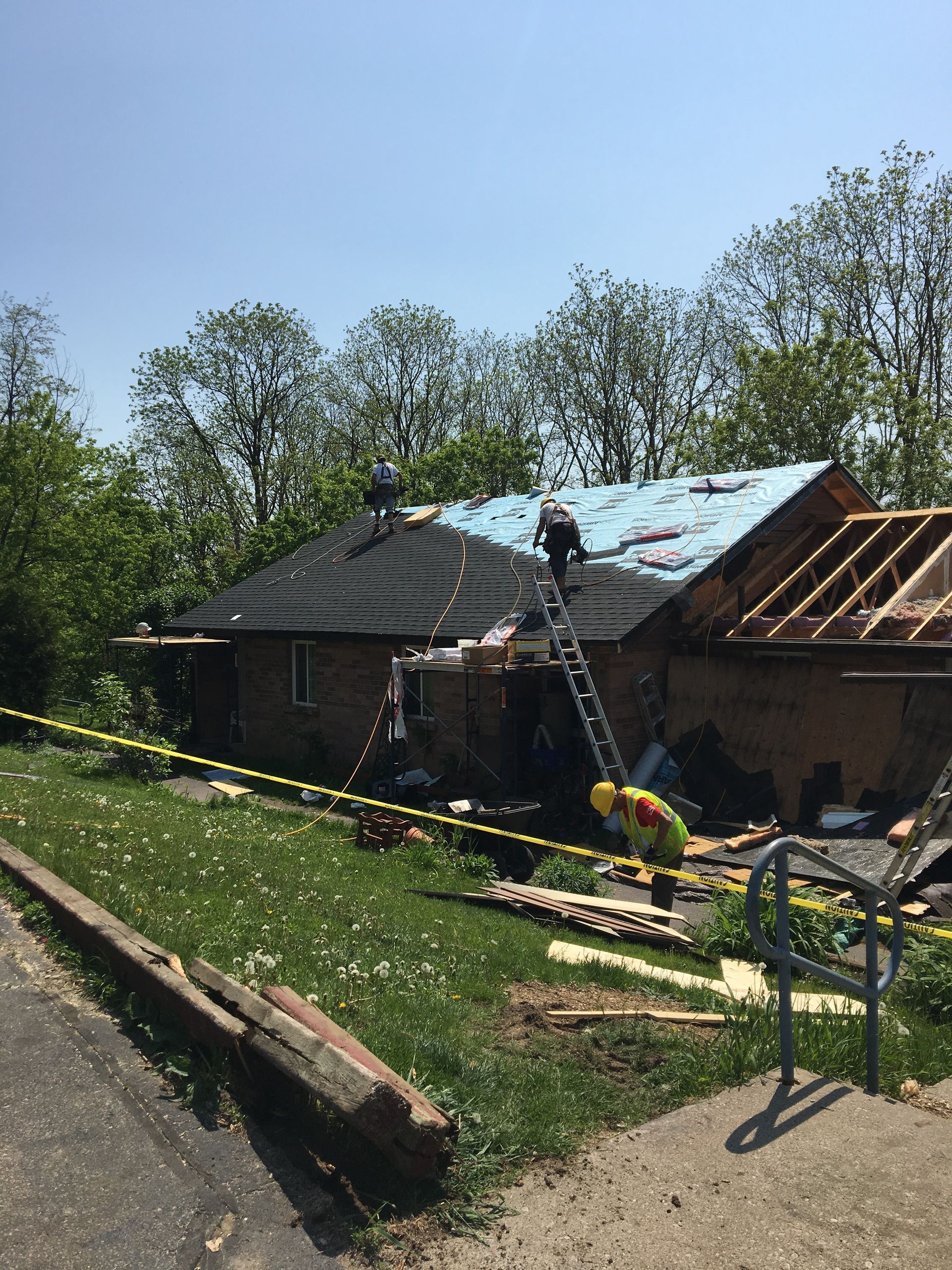 A man is working on the roof of a house.