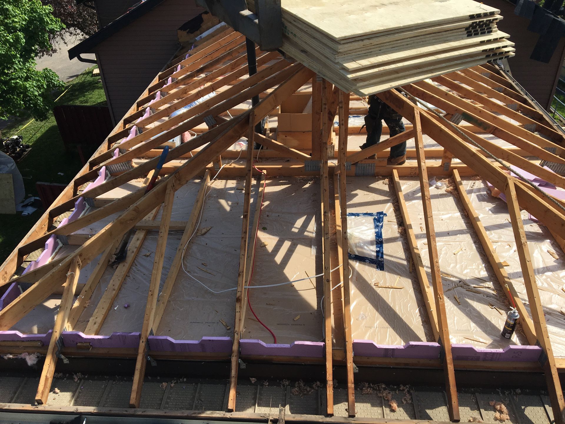 The roof of a house is being built with wooden beams.