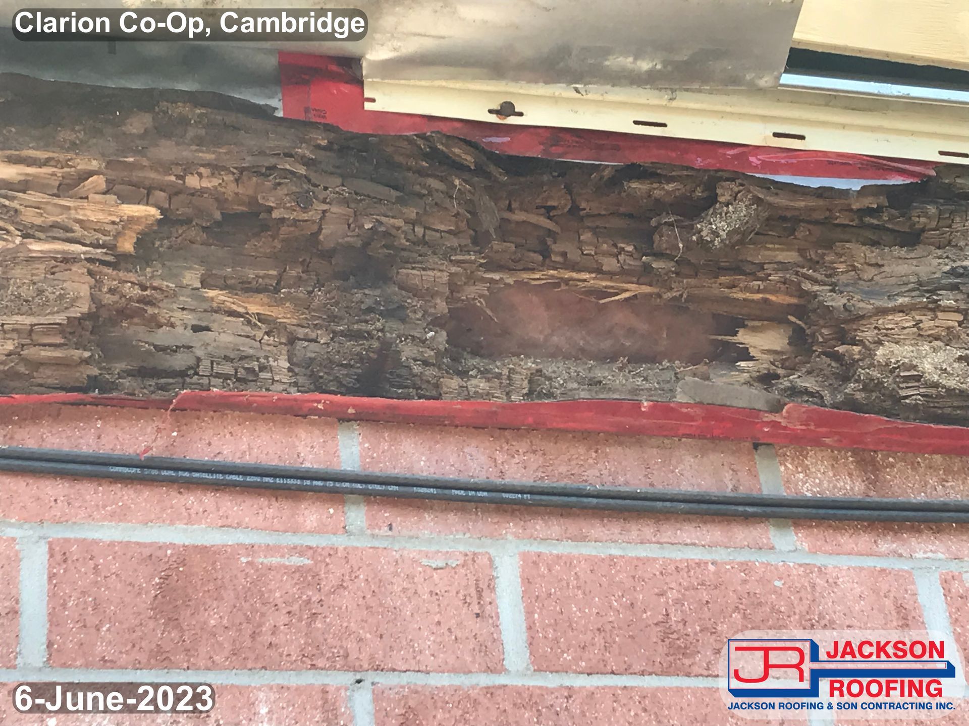 A brick wall with a piece of wood on it