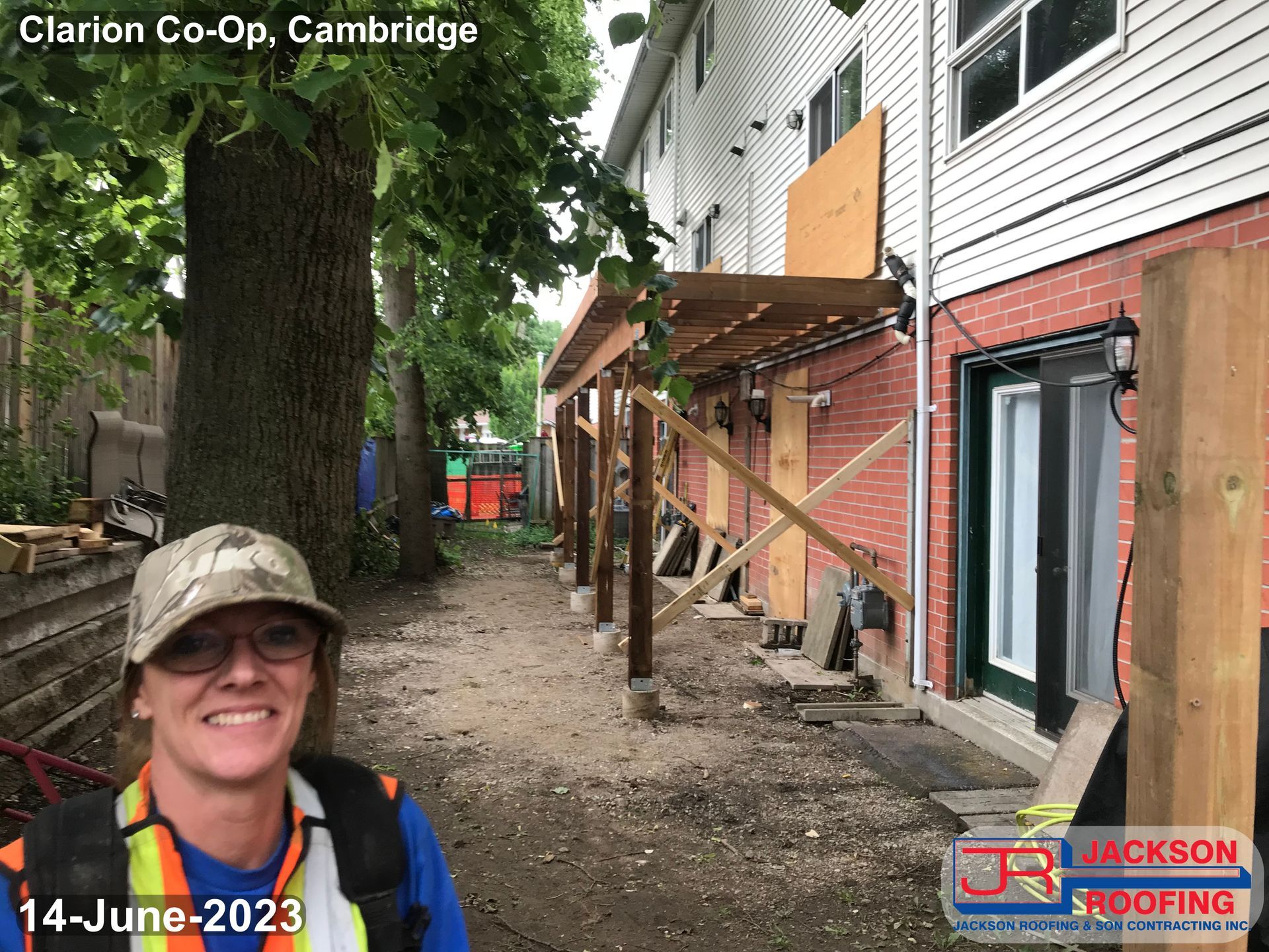 A woman is standing in front of a building under construction.