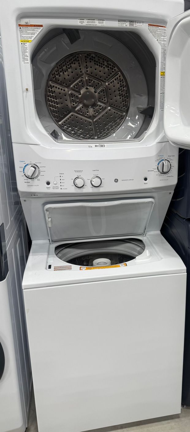 White, stacked washer and dryer with open top door and control panel.