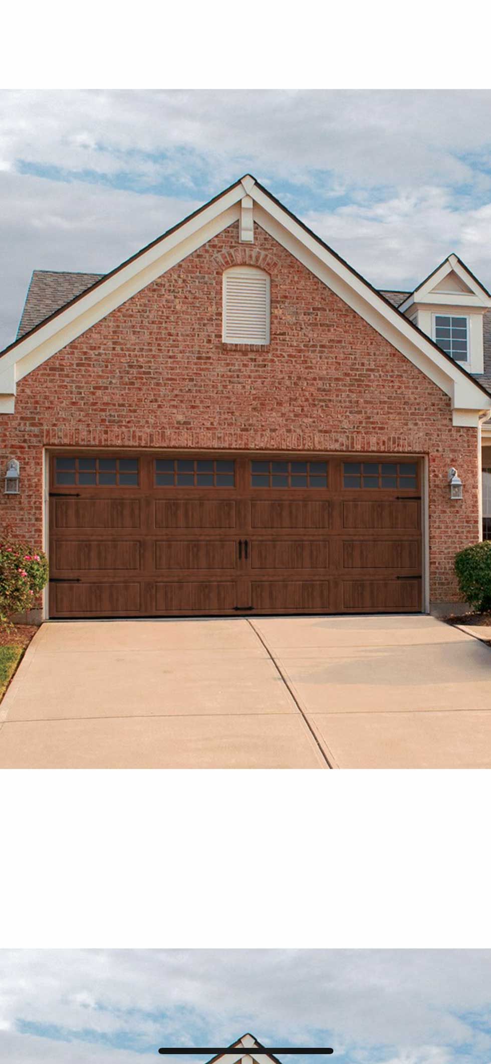 Brick house with brown garage doors and a concrete driveway.