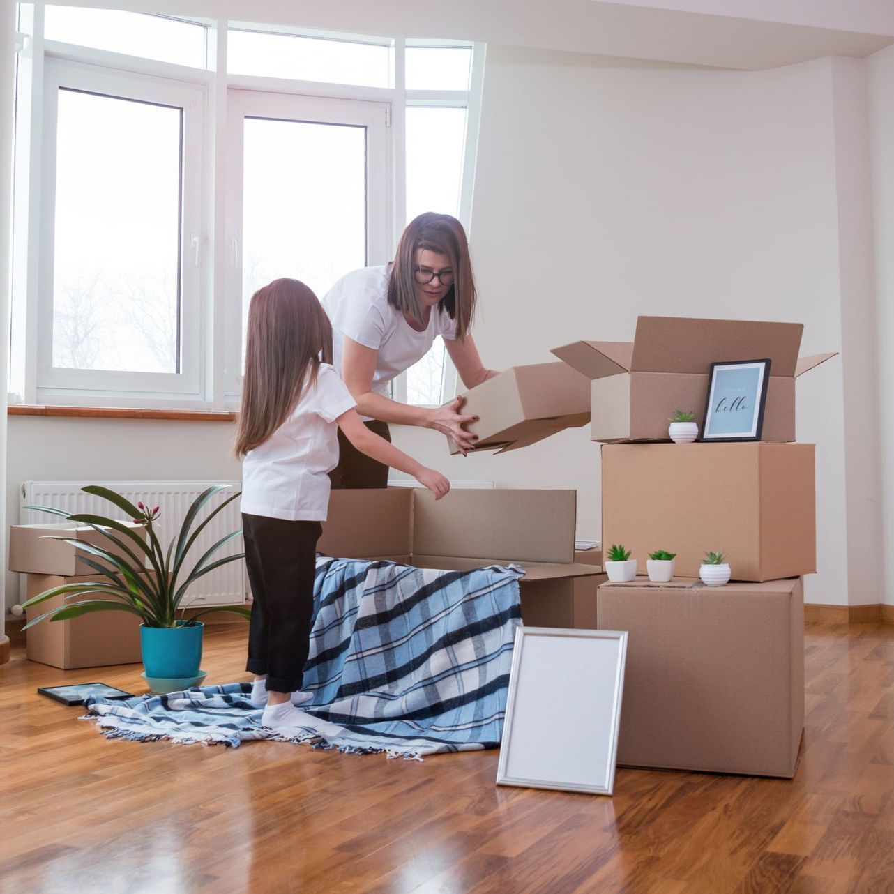 Mother and child opening boxes