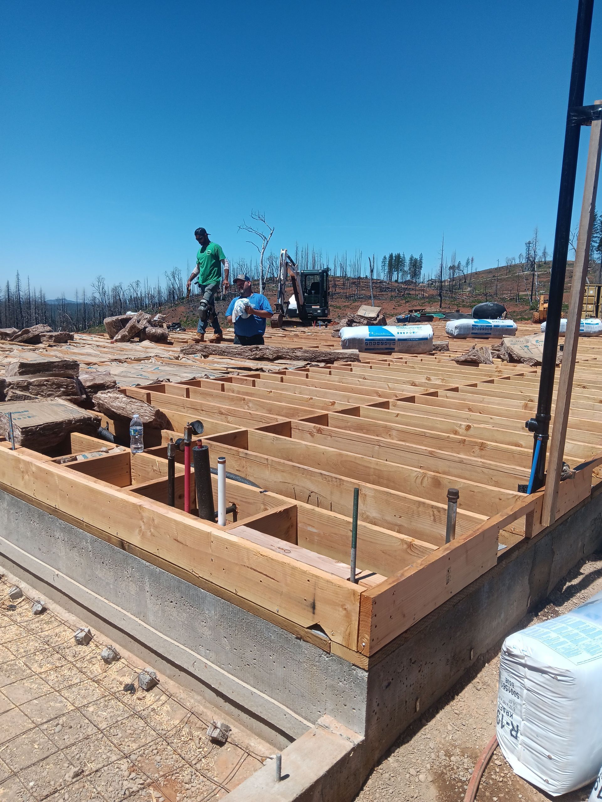 A group of people are working on a wooden structure.