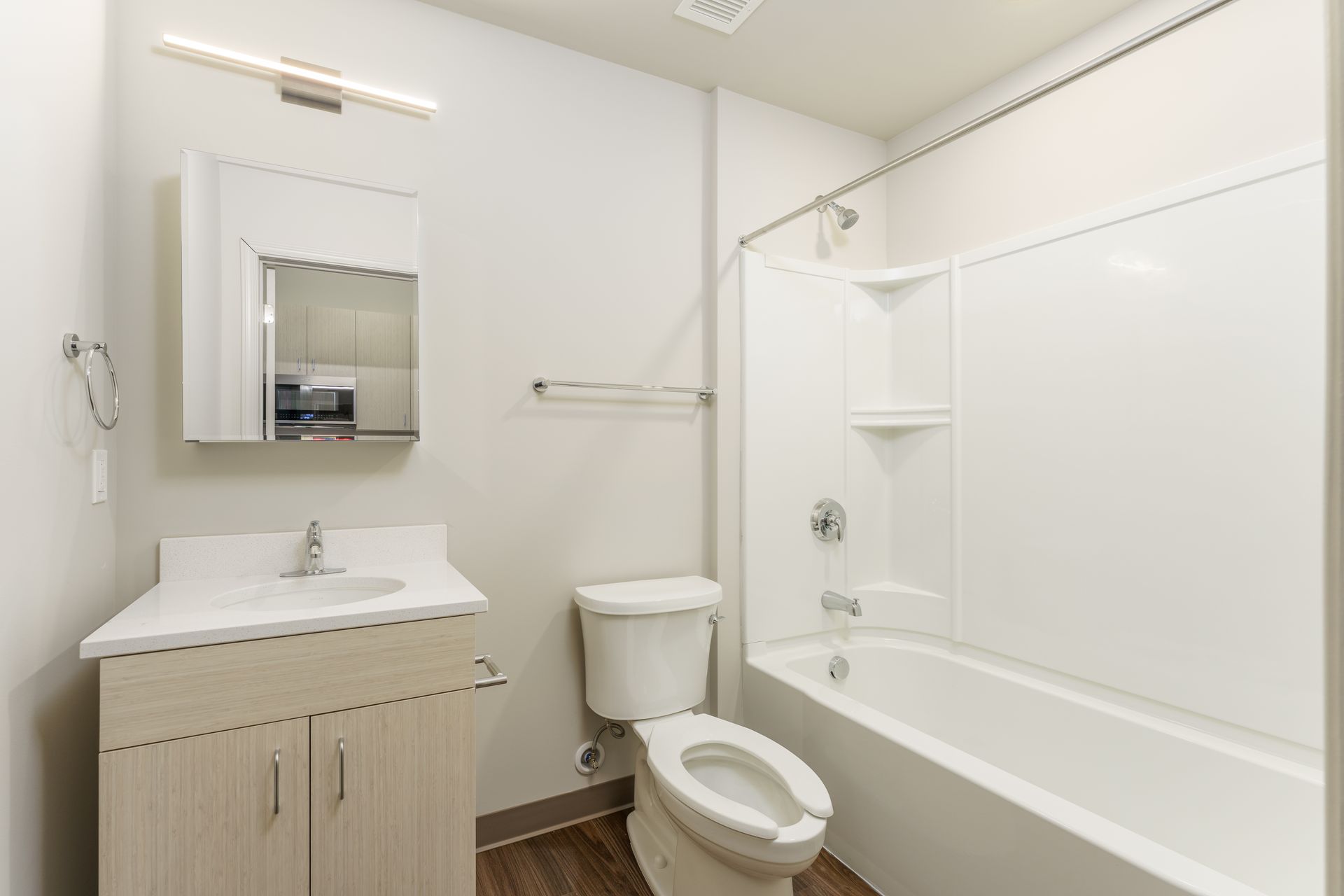 A bathroom with a toilet , sink , and bathtub.